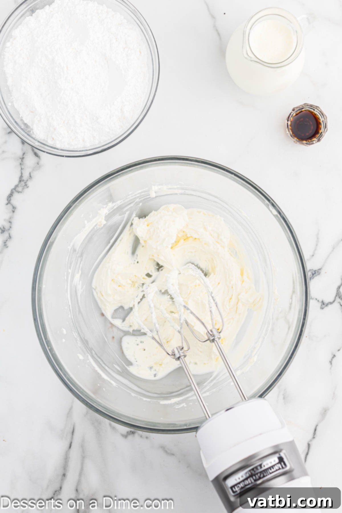 Mixing bowl with cream cheese being beat. 