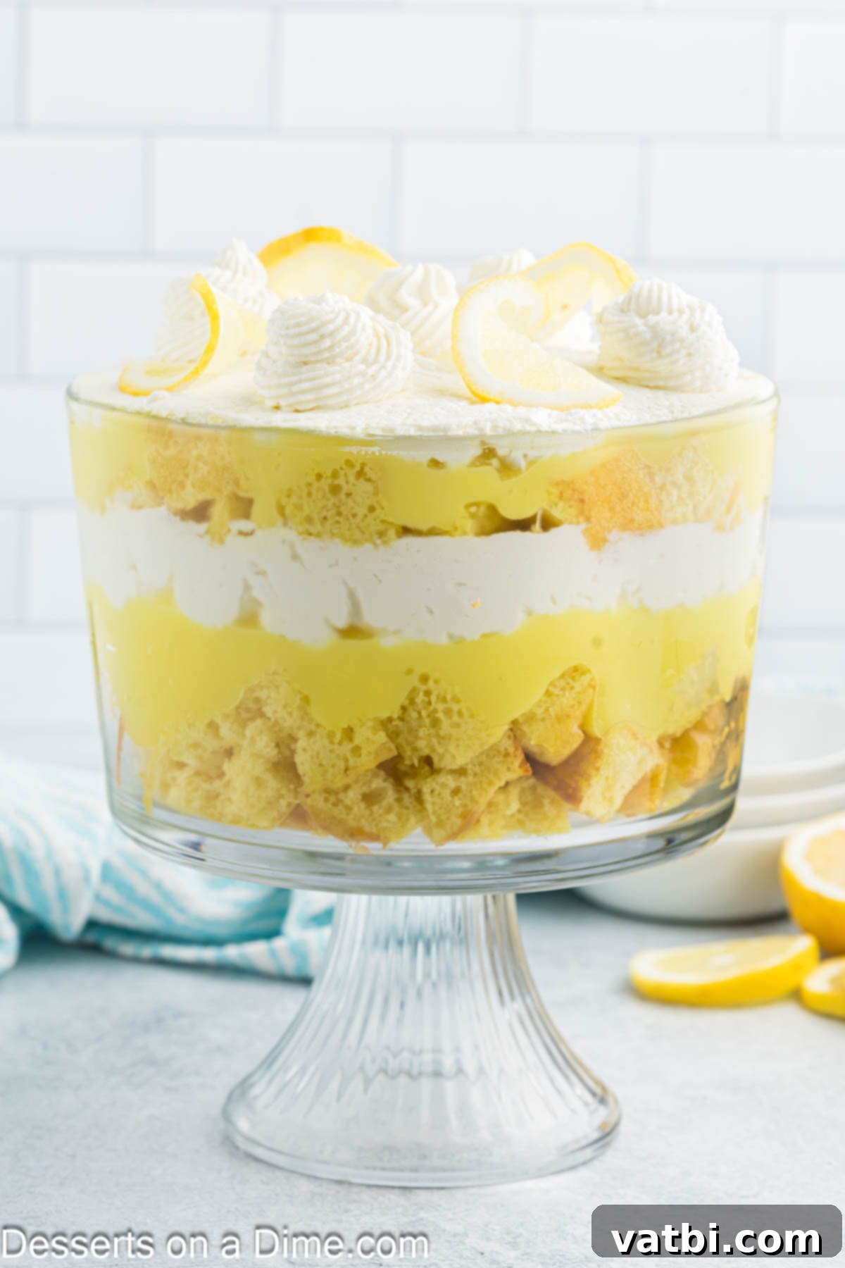Zesty Lemon Layers 2 Lemon trifle layered in a dish and ready to serve, showcasing vibrant yellow and white layers.
