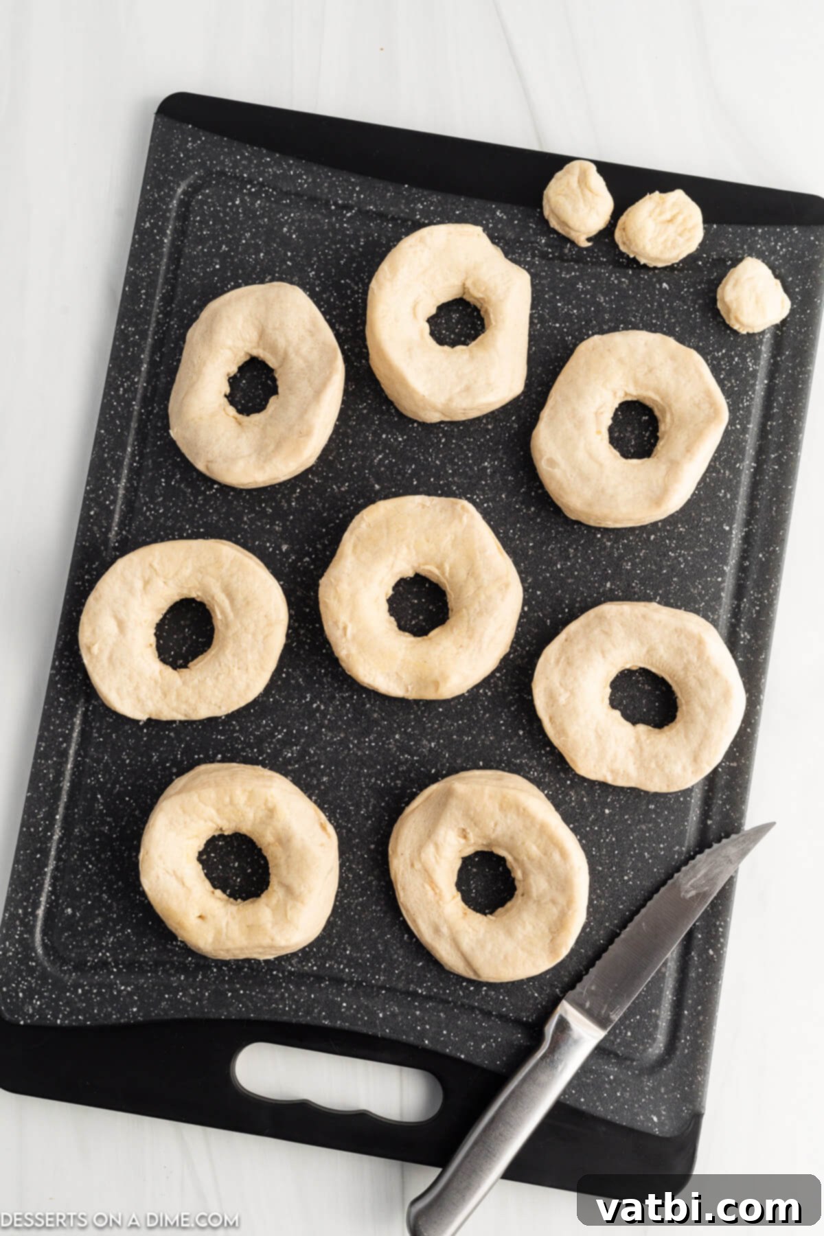 Delicious Air Fryer Donuts Made Easy 3 Donuts on cutting board.