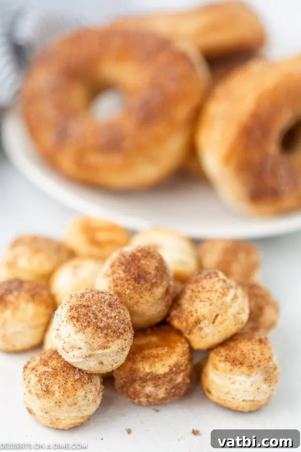 Delicious Air Fryer Donuts Made Easy 9 Close up of donut holes with the donuts in the back ground