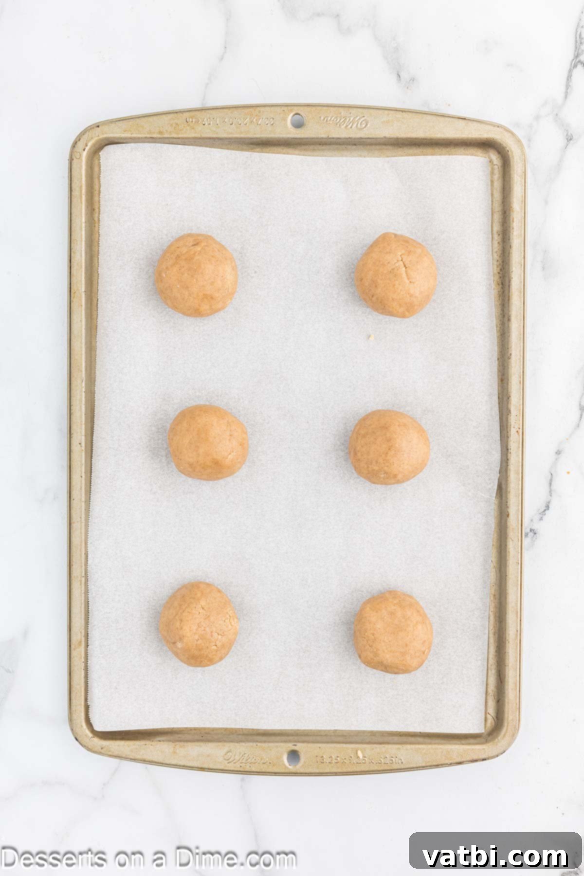 Cinnamon Streusel Cookies 7 Dough balls placed on baking sheet with parchment paper.