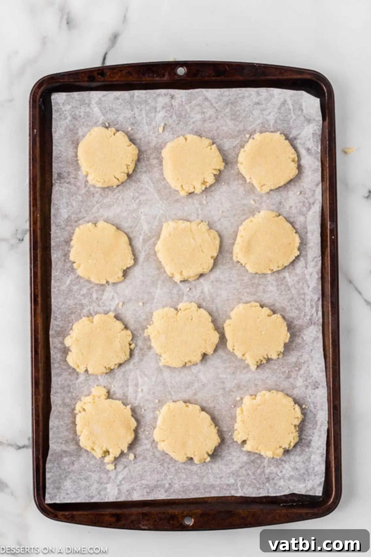 Buttery Gluten-Free Shortbread Bliss 7 Cookies flattened with a glass on baking sheet.