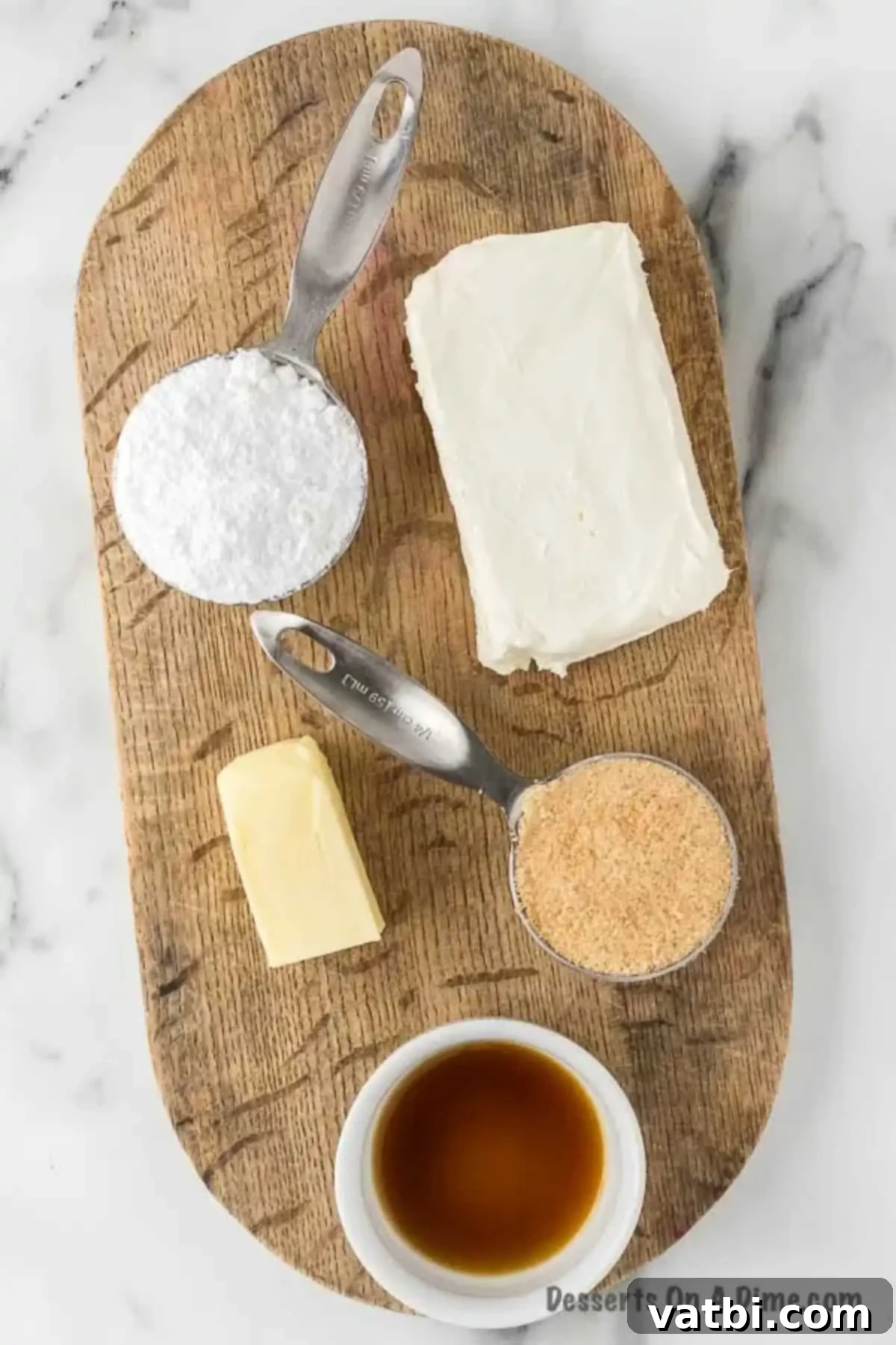 A collection of ingredients for cheesecake dip, including softened cream cheese, real butter, powdered sugar, brown sugar, and vanilla extract.