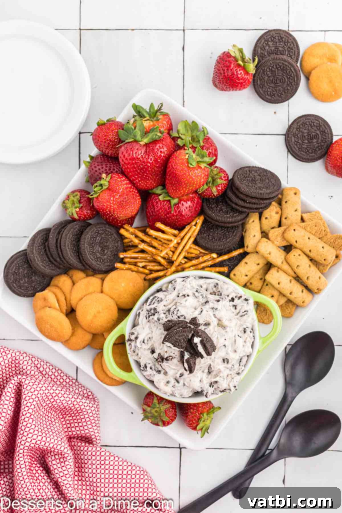 Oreo Dip in a bowl surrounded by dippers including strawberries and graham crackers.