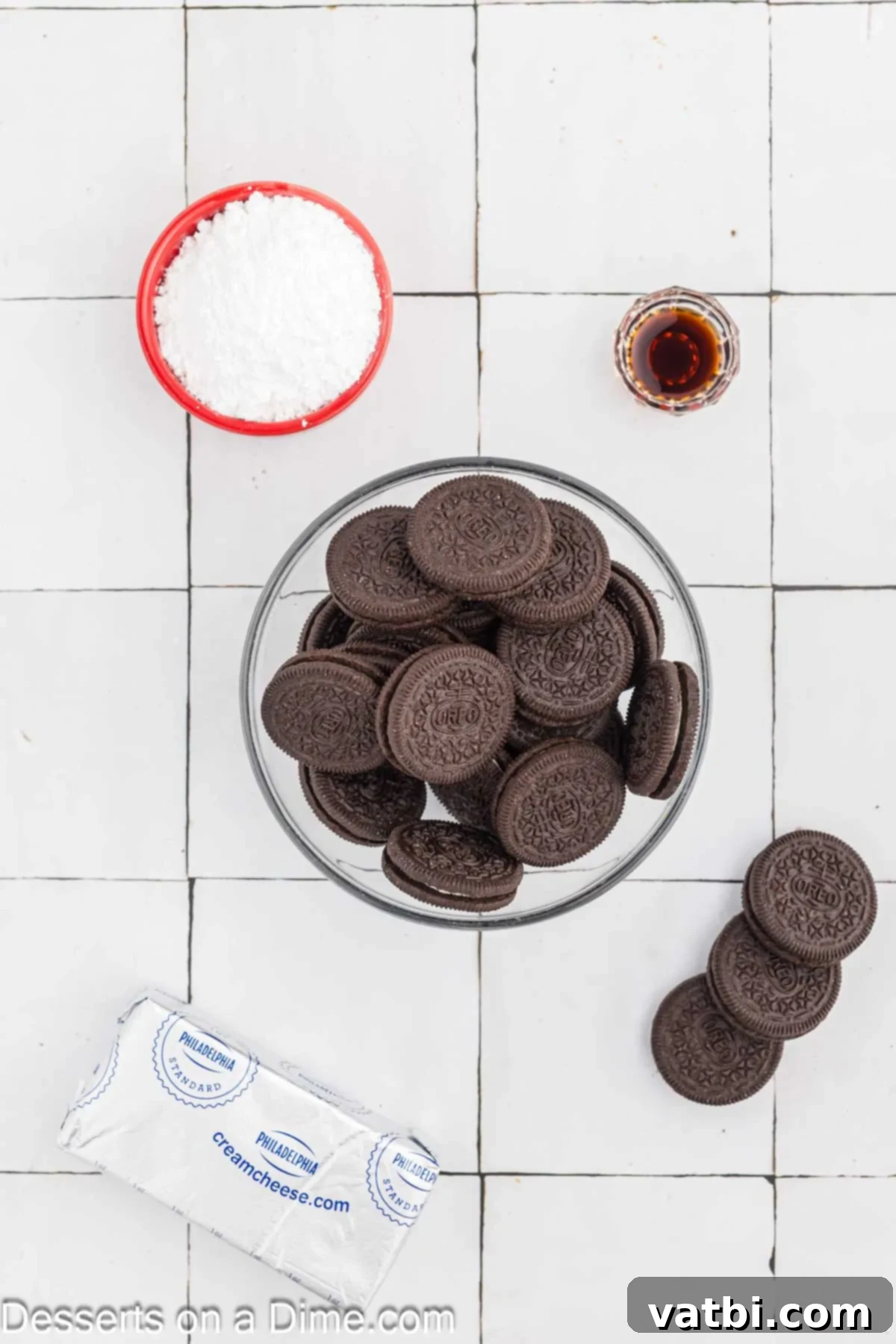 Ingredients for Oreo Dip - cream cheese, powdered sugar, vanilla, oreo cookies laid out on a table.