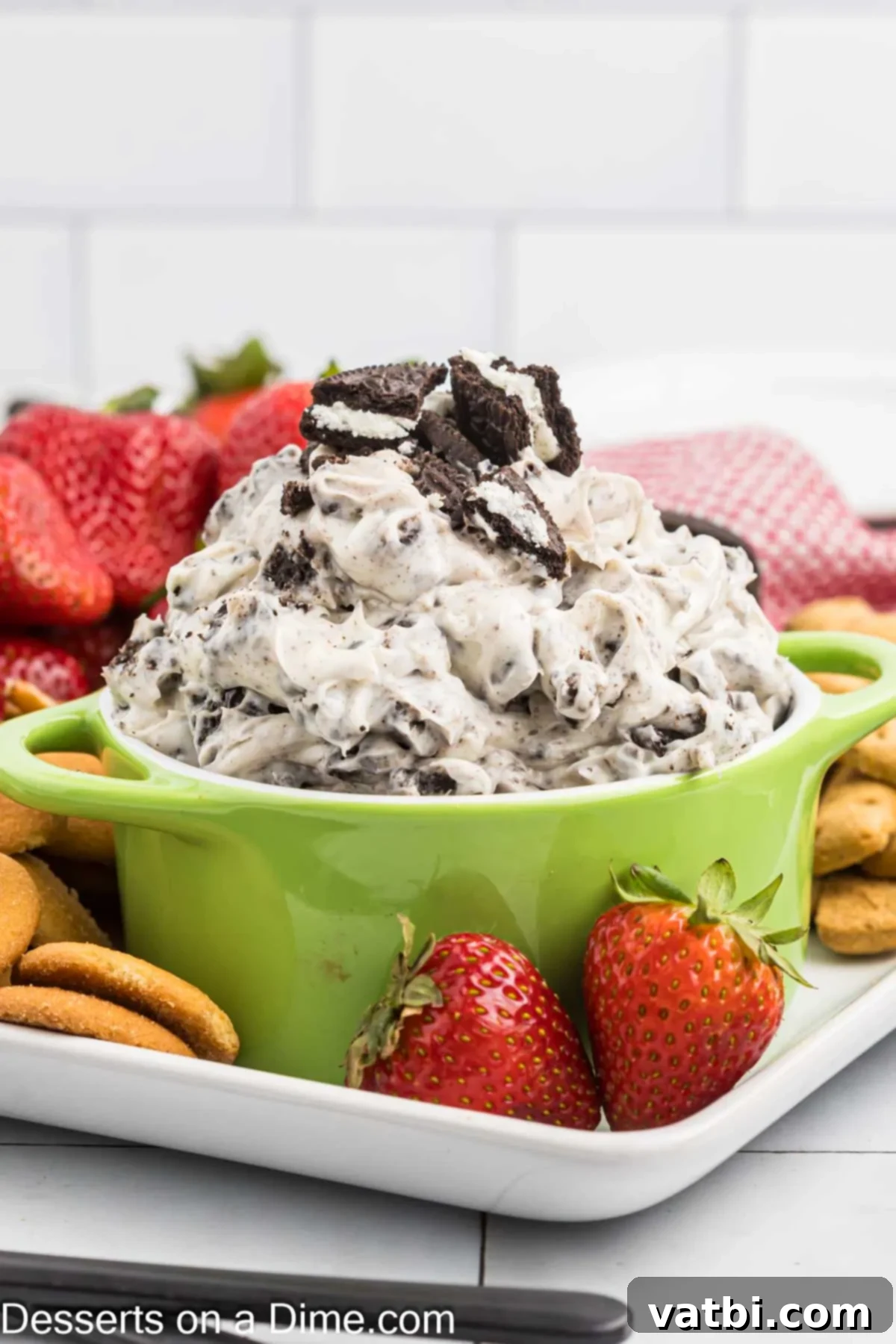 Oreo Dip in a bowl served with a variety of dippers on a platter.