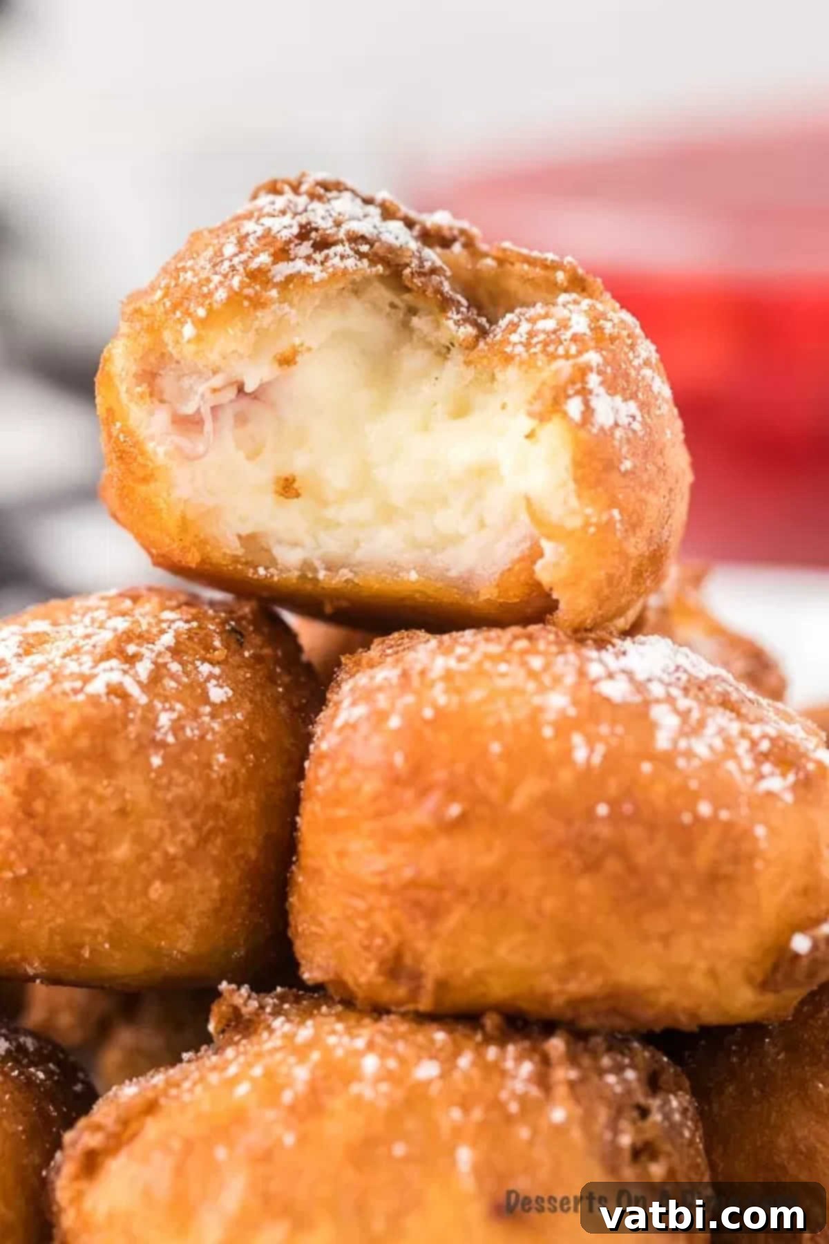 Golden Crisp Cheesecake Indulgence 2 Close-up image of Deep Fried Cheesecake Bites stacked, showcasing their crispy crust and soft interior.