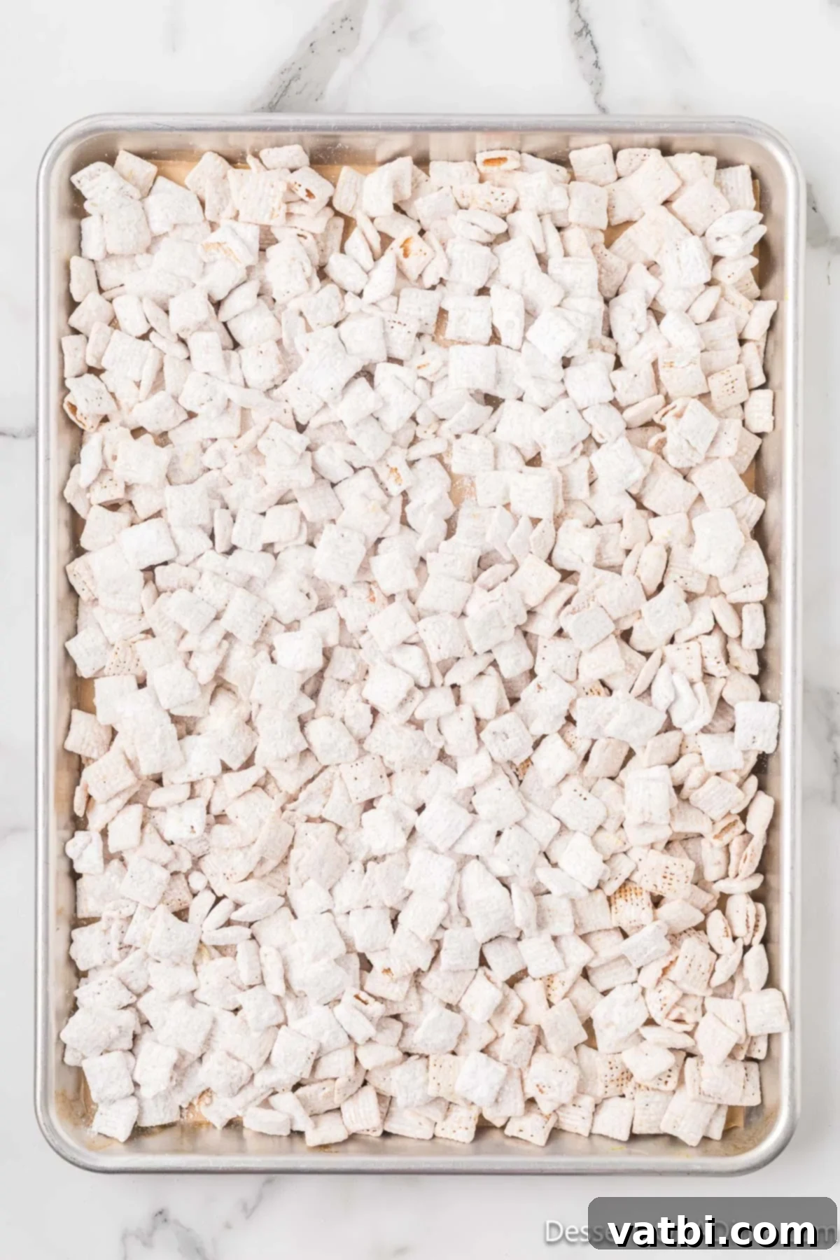 Cereal mixture spread on baking sheet. 