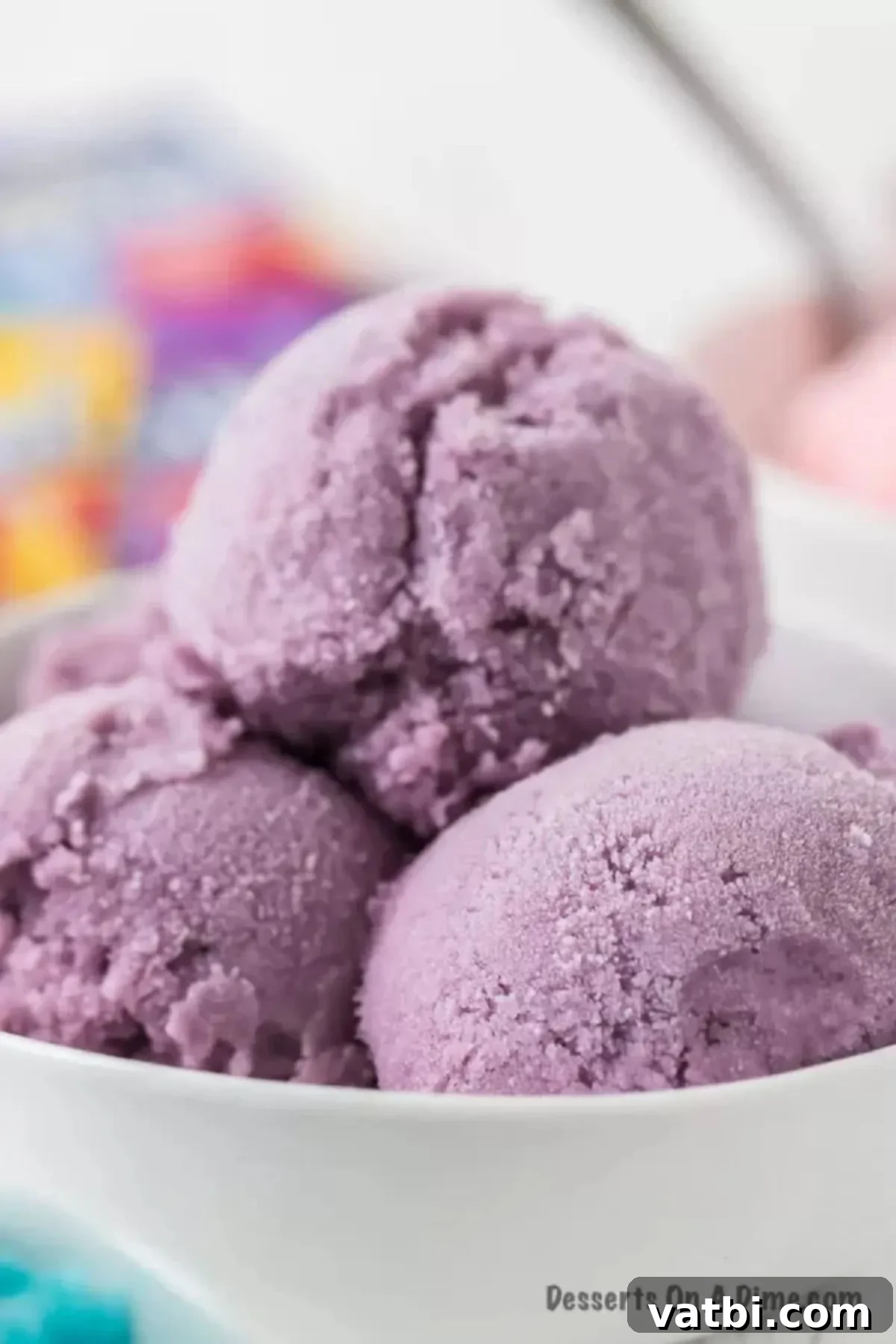 No-Churn Kool-Aid Ice Cream Magic 8 Purple Kool Aid Ice Cream in a white bowl.