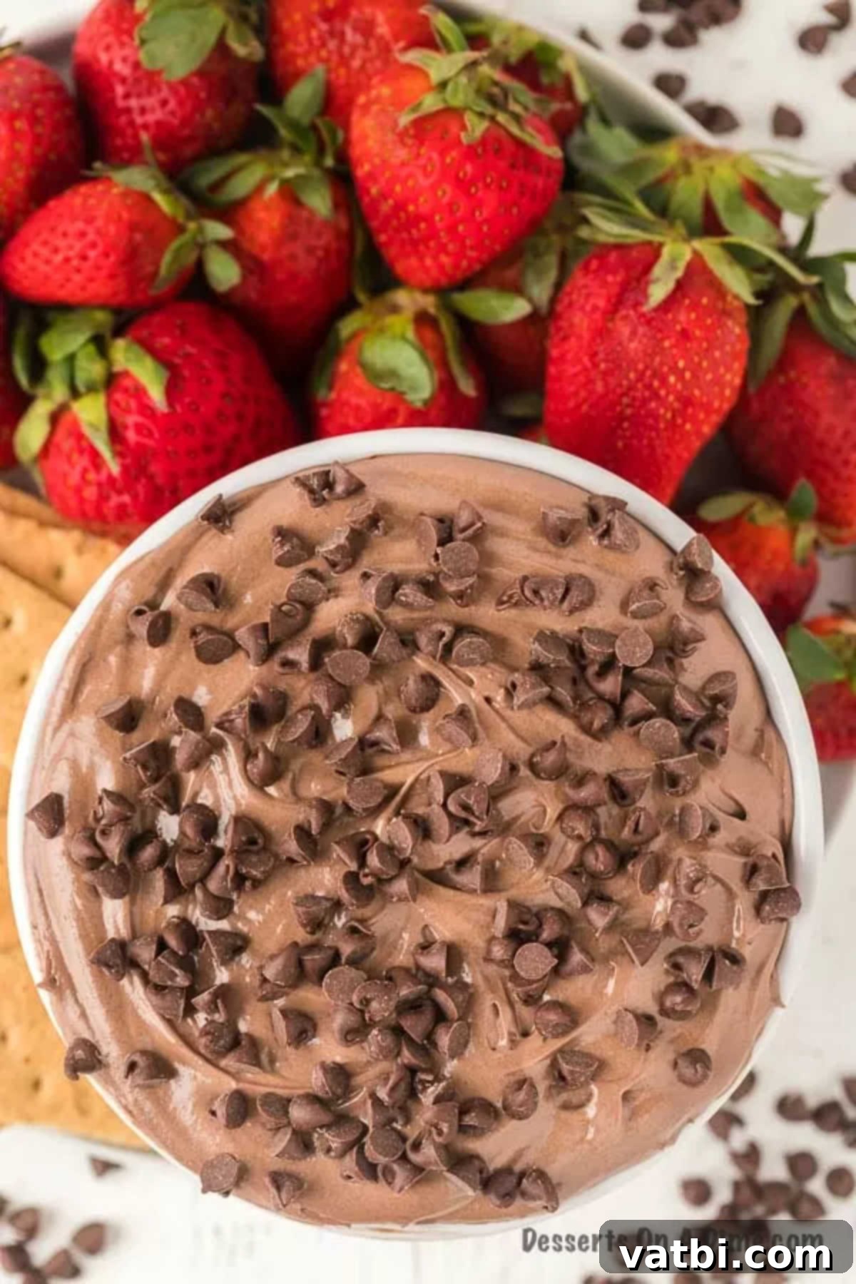 Sweet Brownie Indulgence 2 Brownie dip in a bowl with a side of strawberries and graham crackers, ready to be enjoyed.