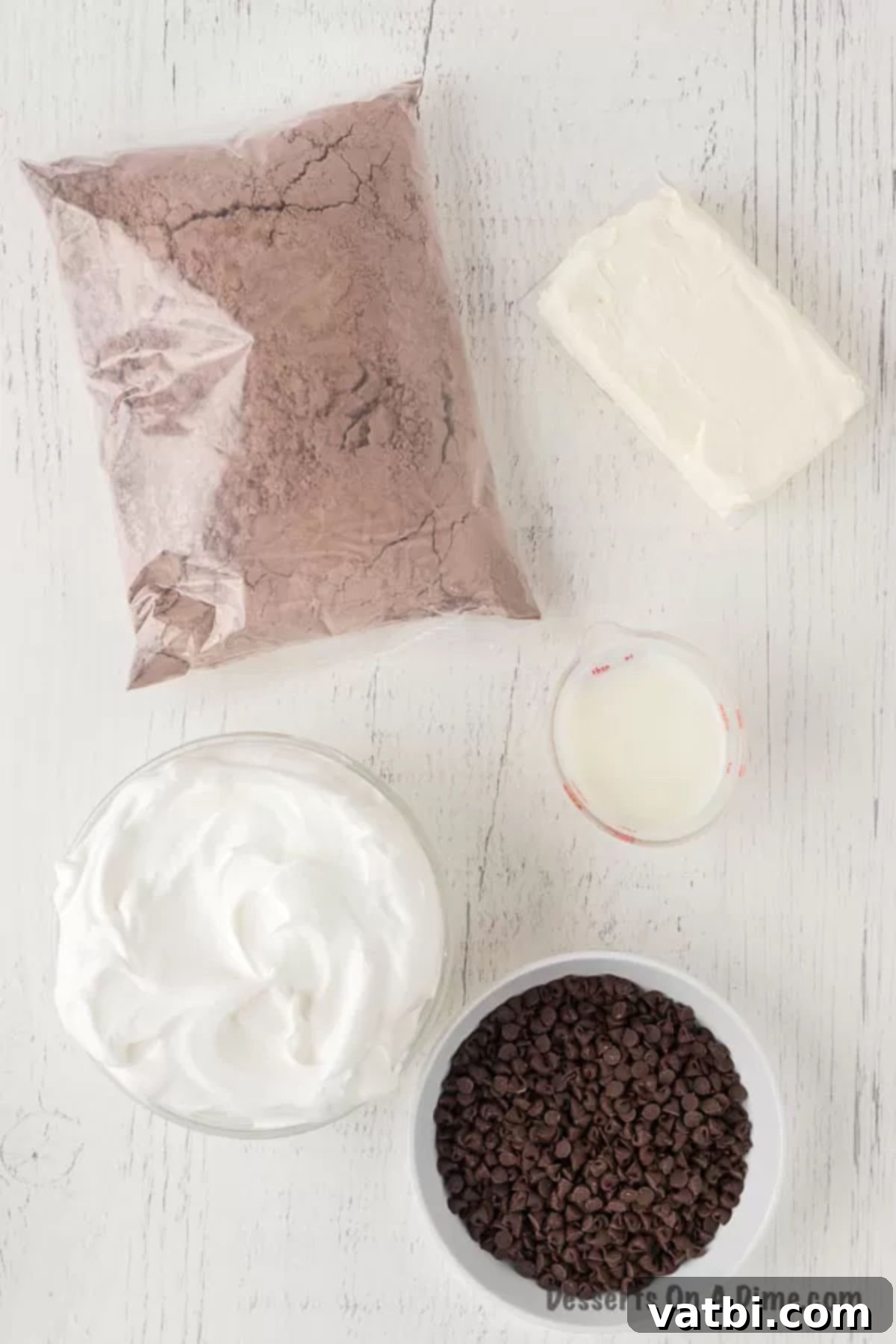 Sweet Brownie Indulgence 3 Key ingredients laid out for brownie dip: cream cheese, whipped topping, brownie mix, milk, and chocolate chips.