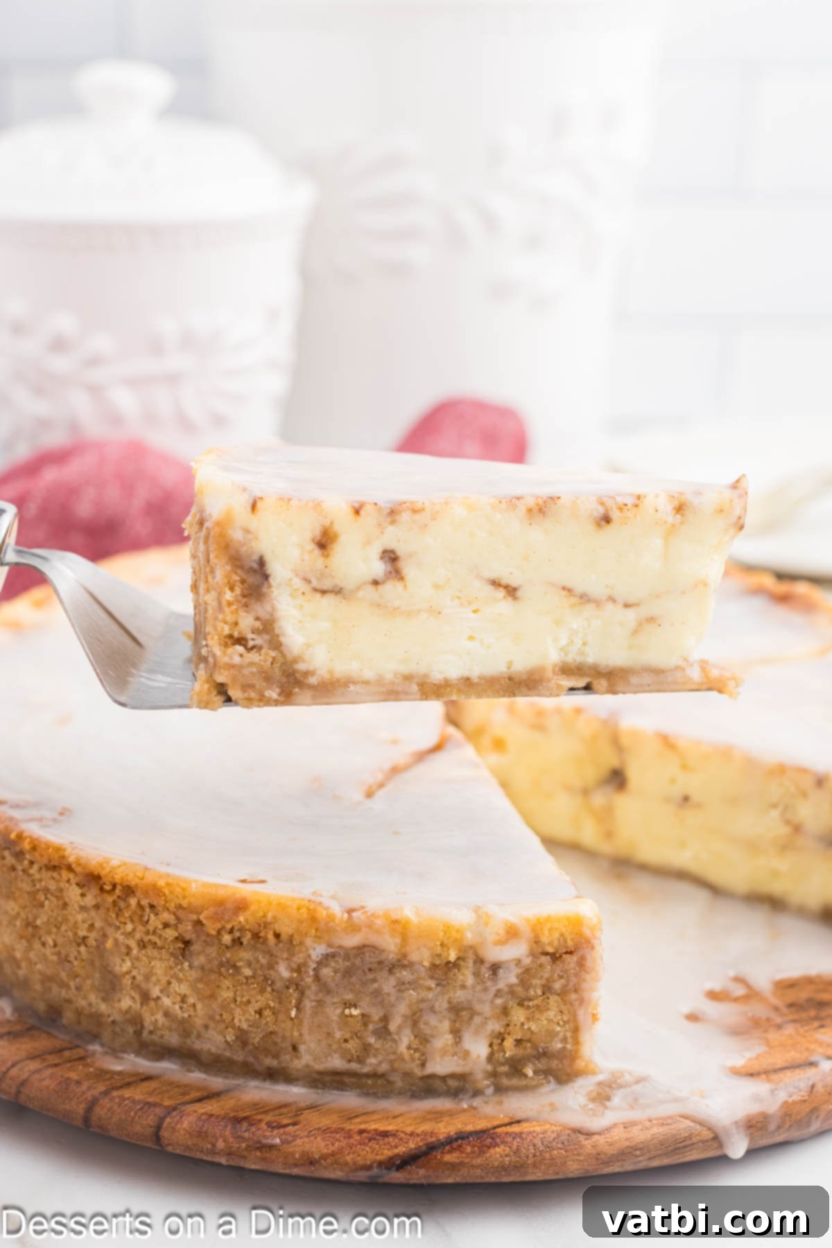 Honey Cinnamon Swirl Cheesecake 2 A freshly baked Honey Bun Cheesecake being expertly sliced, revealing its creamy texture and rich cinnamon swirl.
