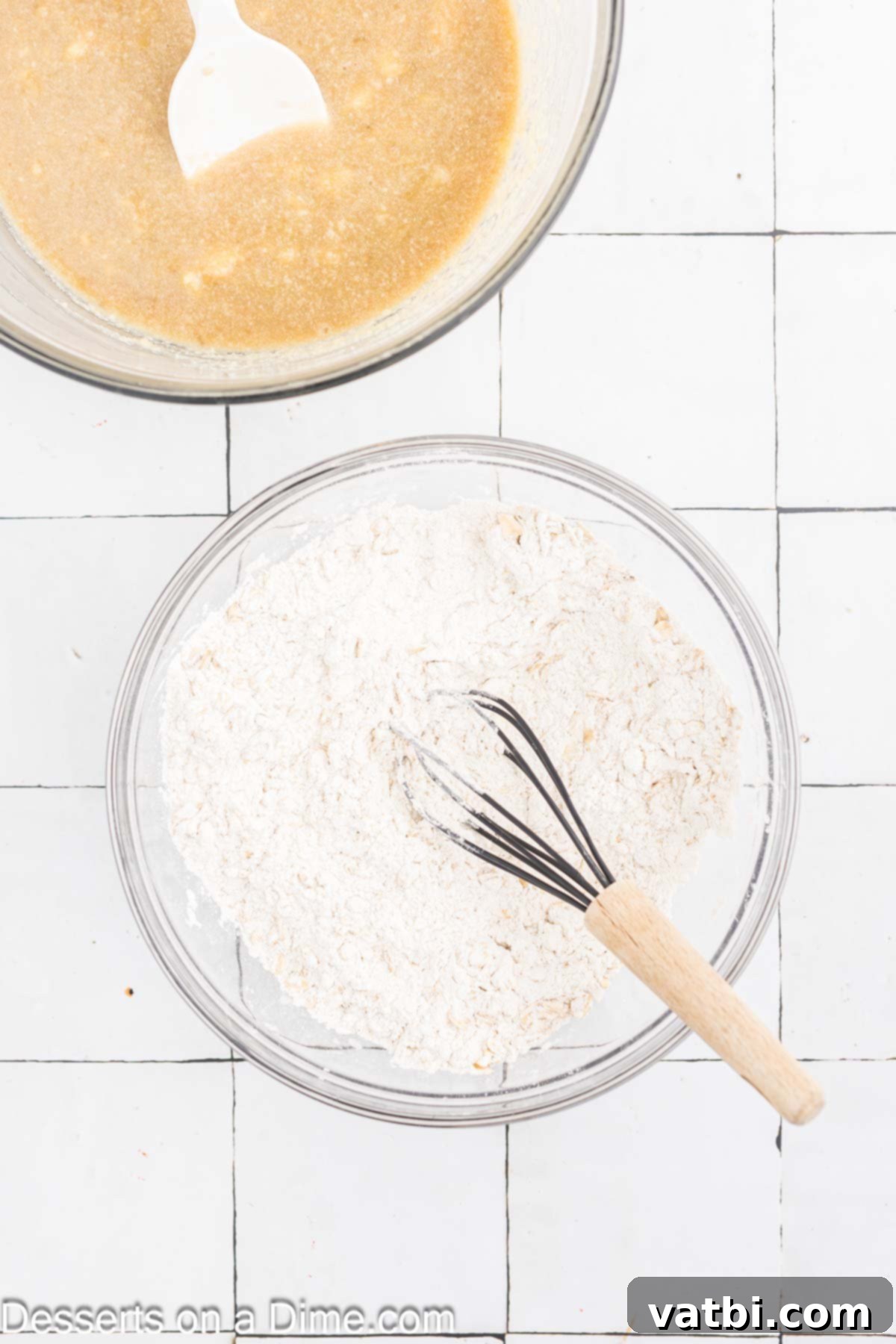 Delicious Banana Oat Bread 6 Dry ingredients including flour, oats, baking powder, baking soda, cinnamon, nutmeg, and salt are whisked together in a separate bowl.