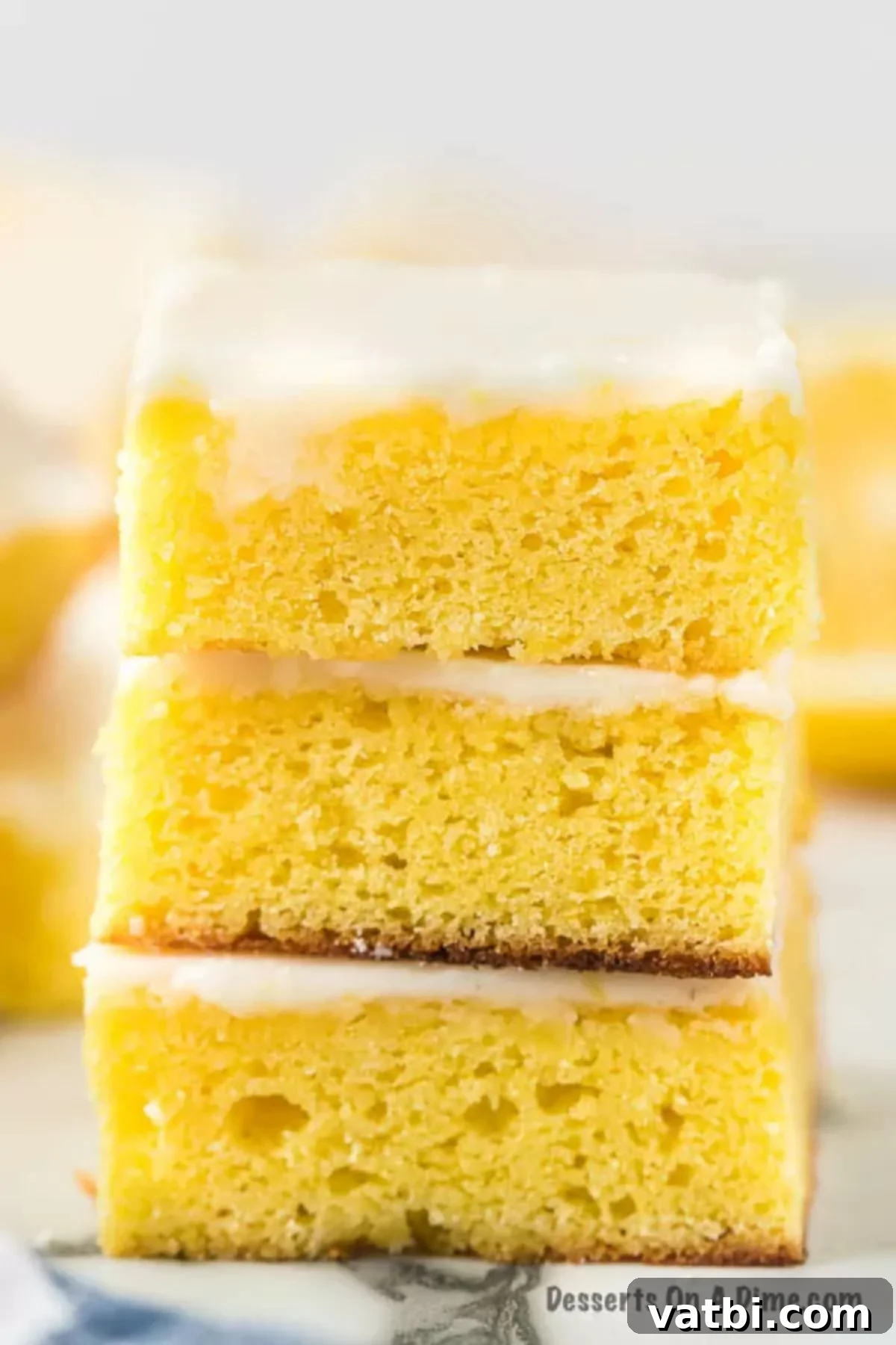 Zesty Lemon Brownie Bliss 2 Homemade Lemon Brownies stacked together, showcasing their soft texture and vibrant glaze.