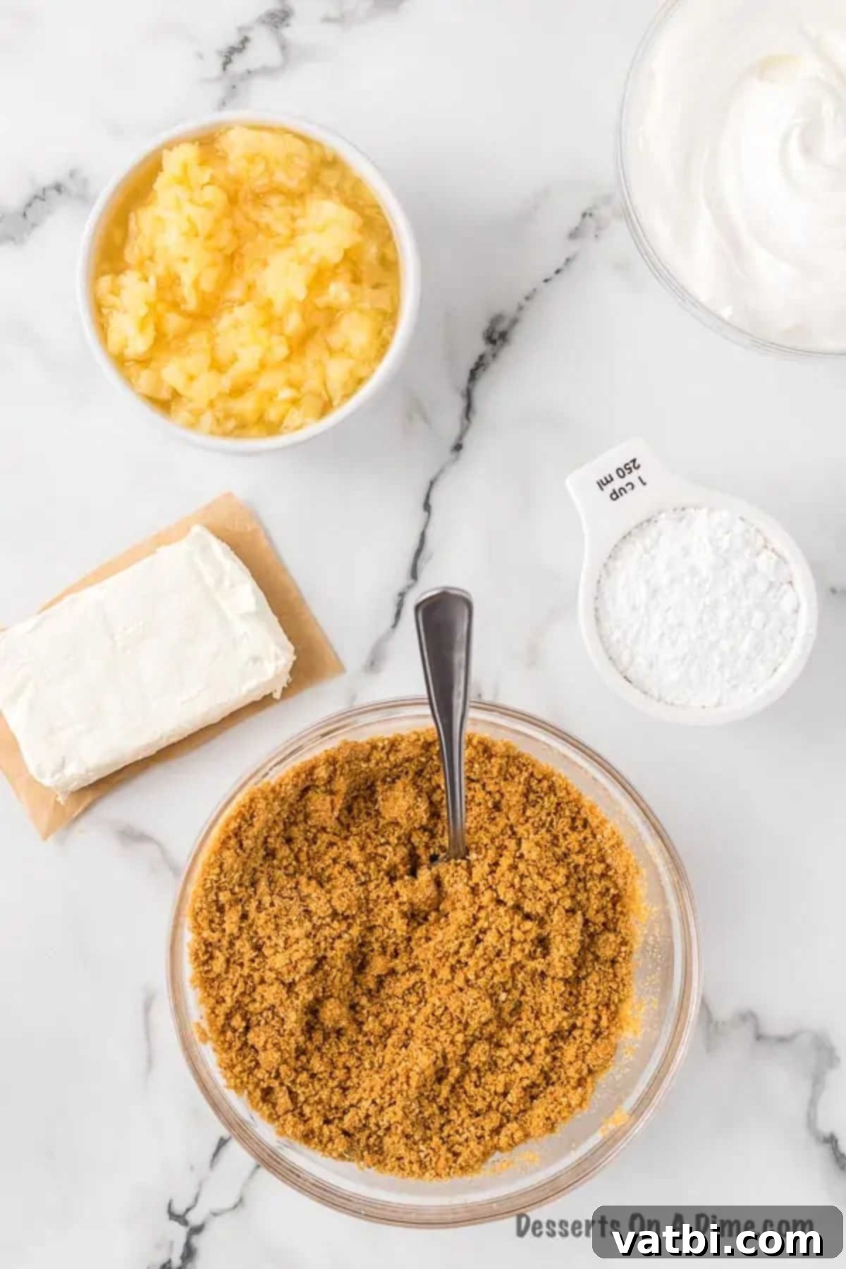 Golden Pineapple Bliss 4 Graham cracker crumbs in a bowl, mixed with melted butter until evenly combined.