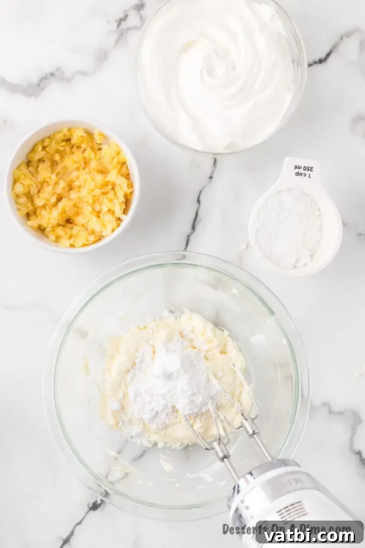 Golden Pineapple Bliss 6 Cream cheese, softened butter, and powdered sugar beaten together in a large bowl, forming a smooth and fluffy filling mixture.