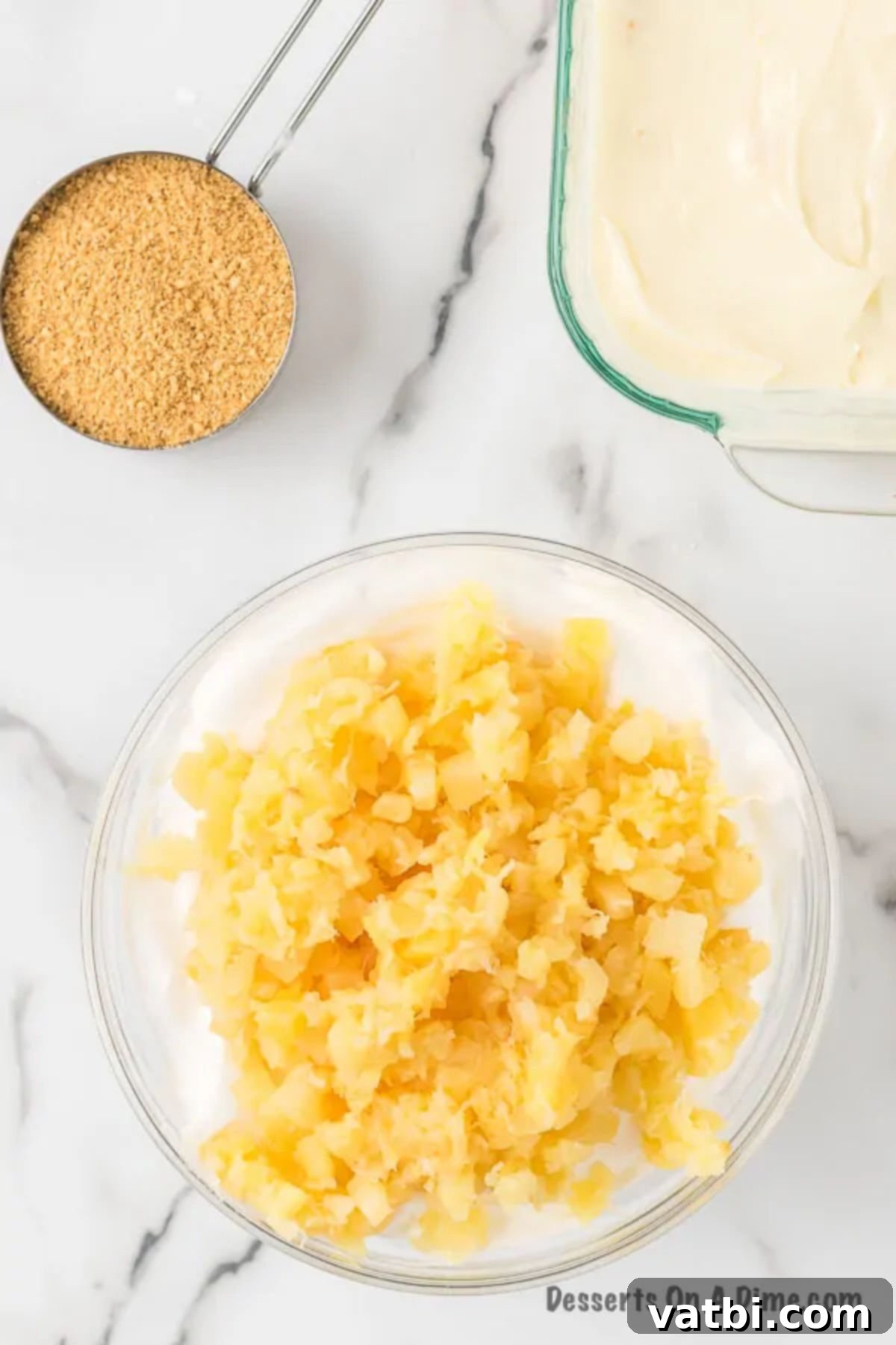 Golden Pineapple Bliss 7 Drained crushed pineapple being gently folded into the cream cheese mixture by hand using a spatula.