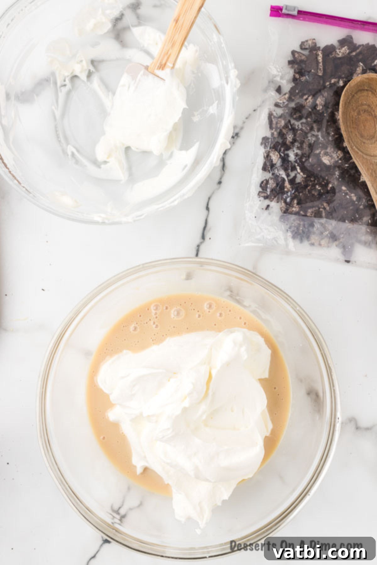 Swirled Cookie Bliss 7 Whipped cream being gently folded into the sweetened condensed milk and vanilla mixture.
