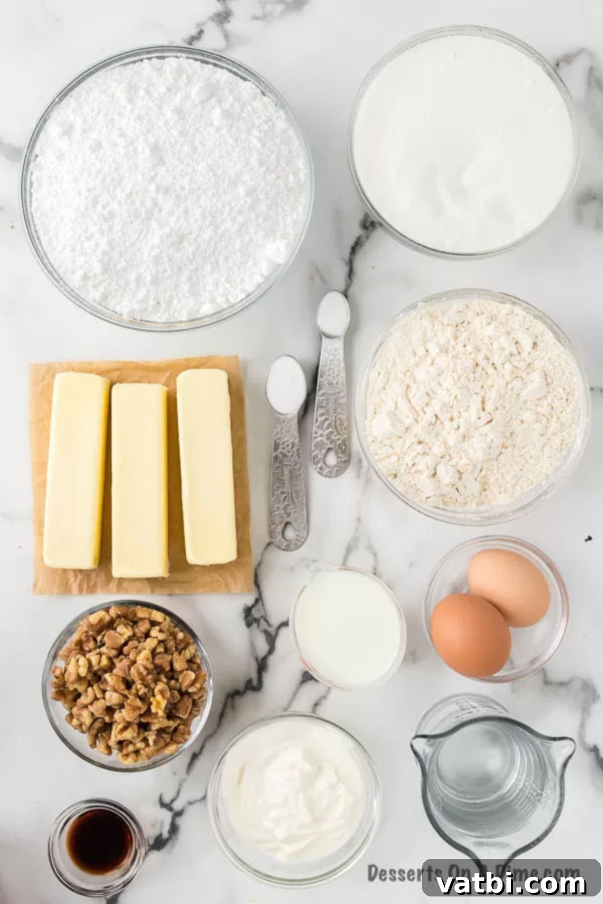 Classic White Sheet Cake 3 Various ingredients laid out for White Texas Sheet Cake: flour, sugar, baking soda, salt, sour cream, eggs, butter, and milk.
