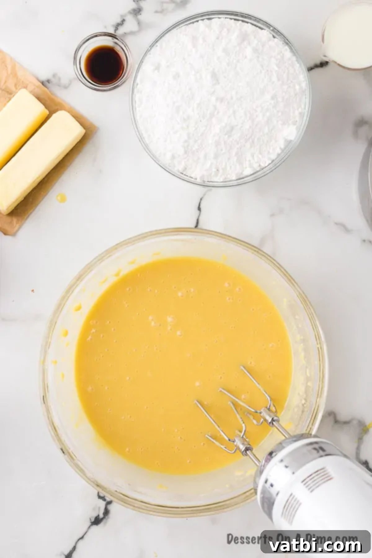 Classic White Sheet Cake 4 Bowl with combined dry ingredients and wet ingredients, creating the cake batter.
