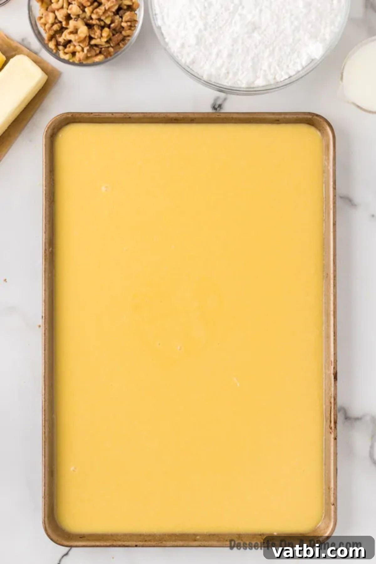 Classic White Sheet Cake 6 Cake batter poured evenly into the prepared baking pan.