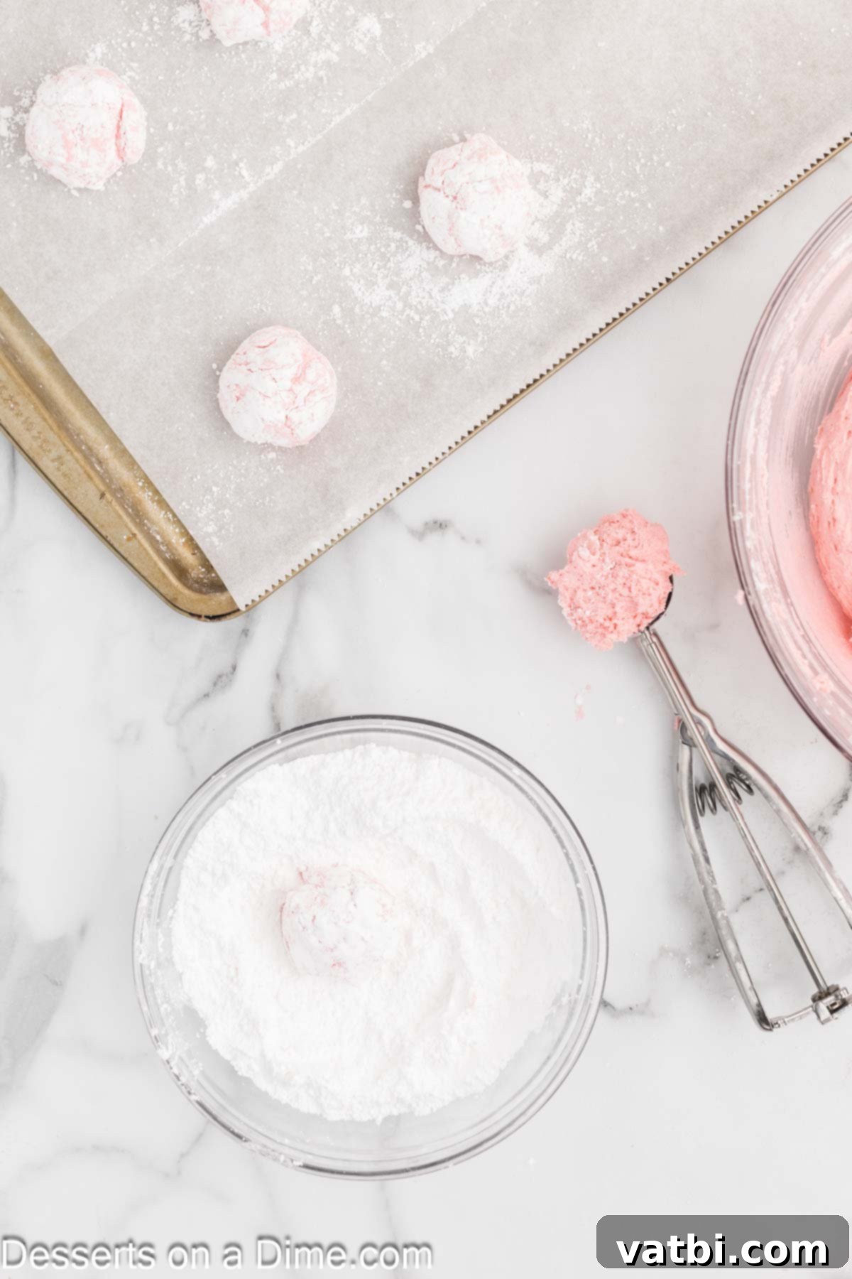 Fluffy Cool Whip Cookies 5 Rounded cookie dough balls coated generously in powdered sugar, ready for baking.