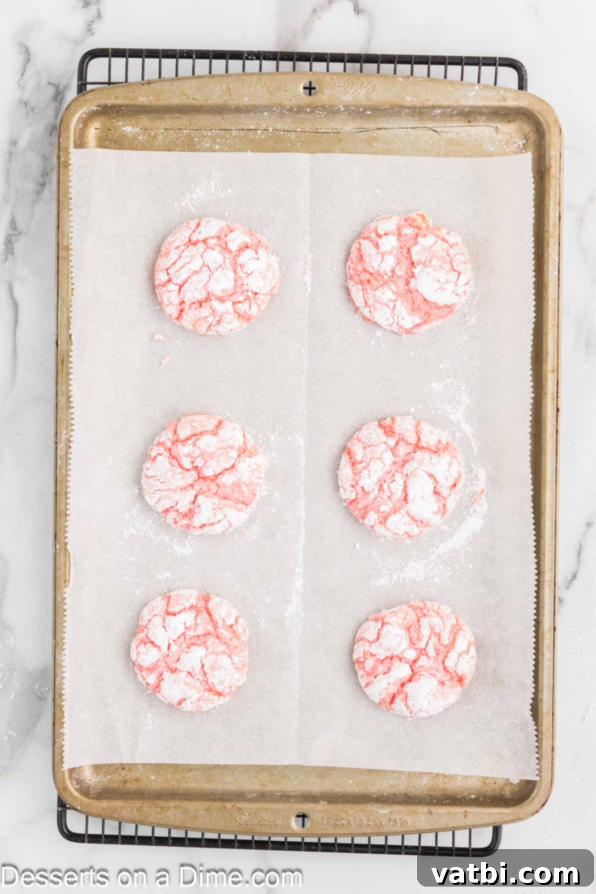 Fluffy Cool Whip Cookies 6 Freshly baked Cool Whip Cookies cooling on a baking sheet, with visible crinkles.