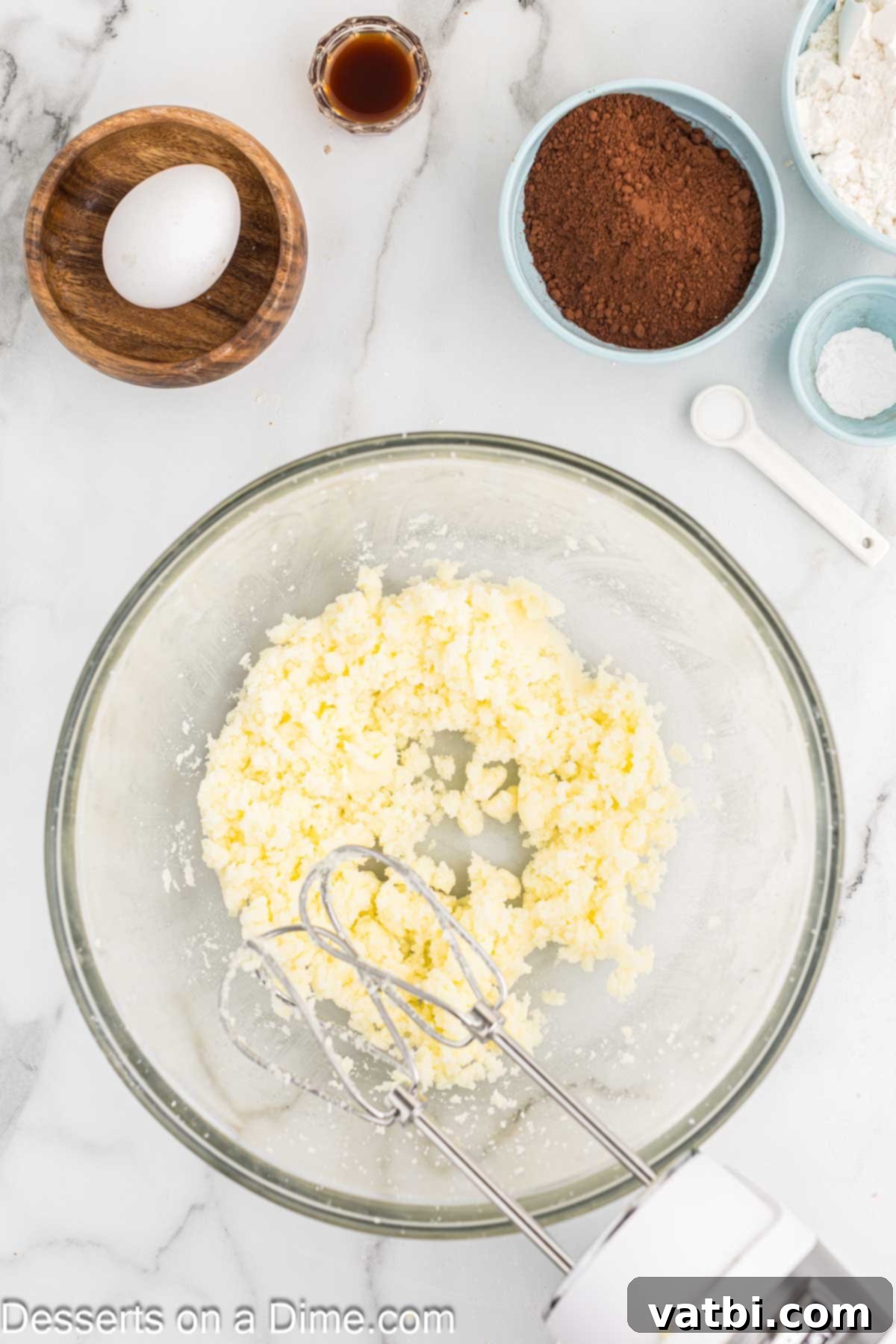 Layered Chocolate Delights 4 Softened butter and granulated sugar thoroughly combined in a mixing bowl, appearing light and creamy.