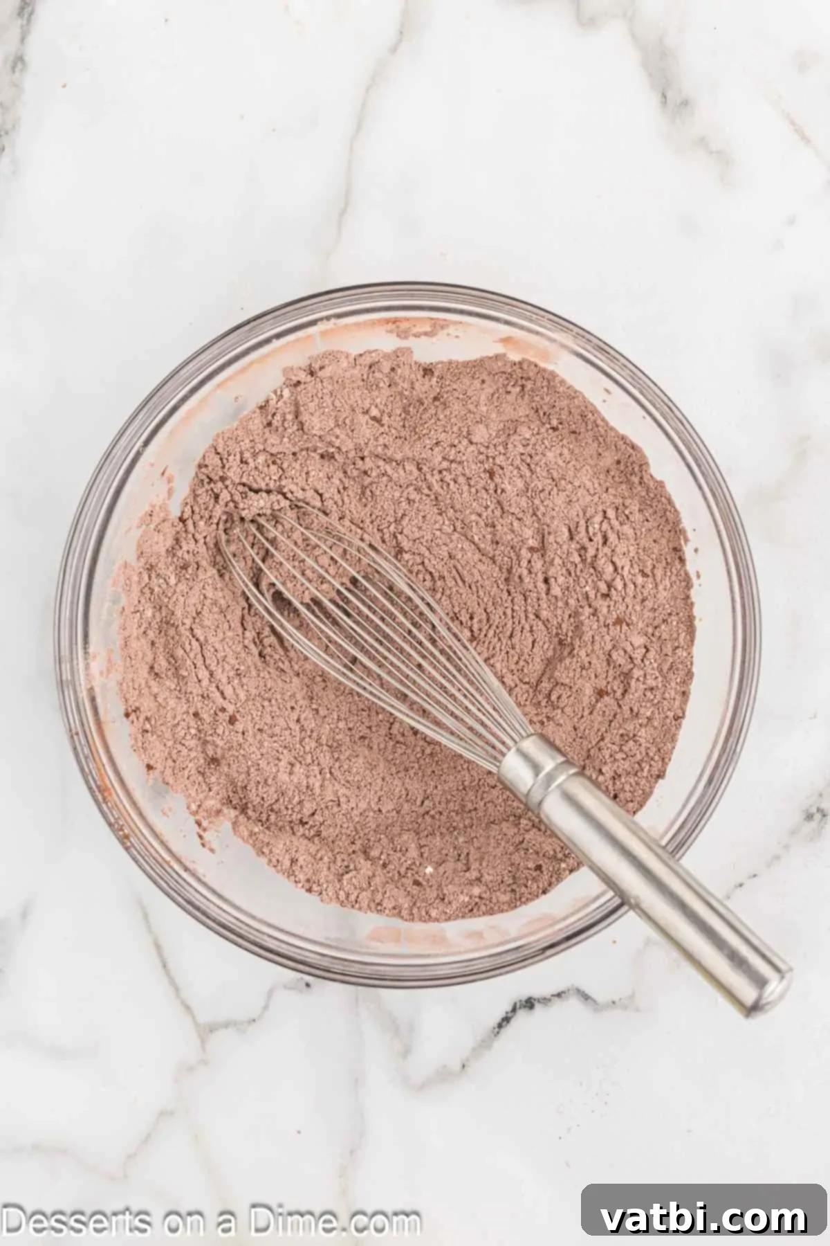 Layered Chocolate Delights 5 A separate medium bowl containing dry ingredients - flour, cocoa powder, baking powder, and salt - whisked together until evenly distributed.