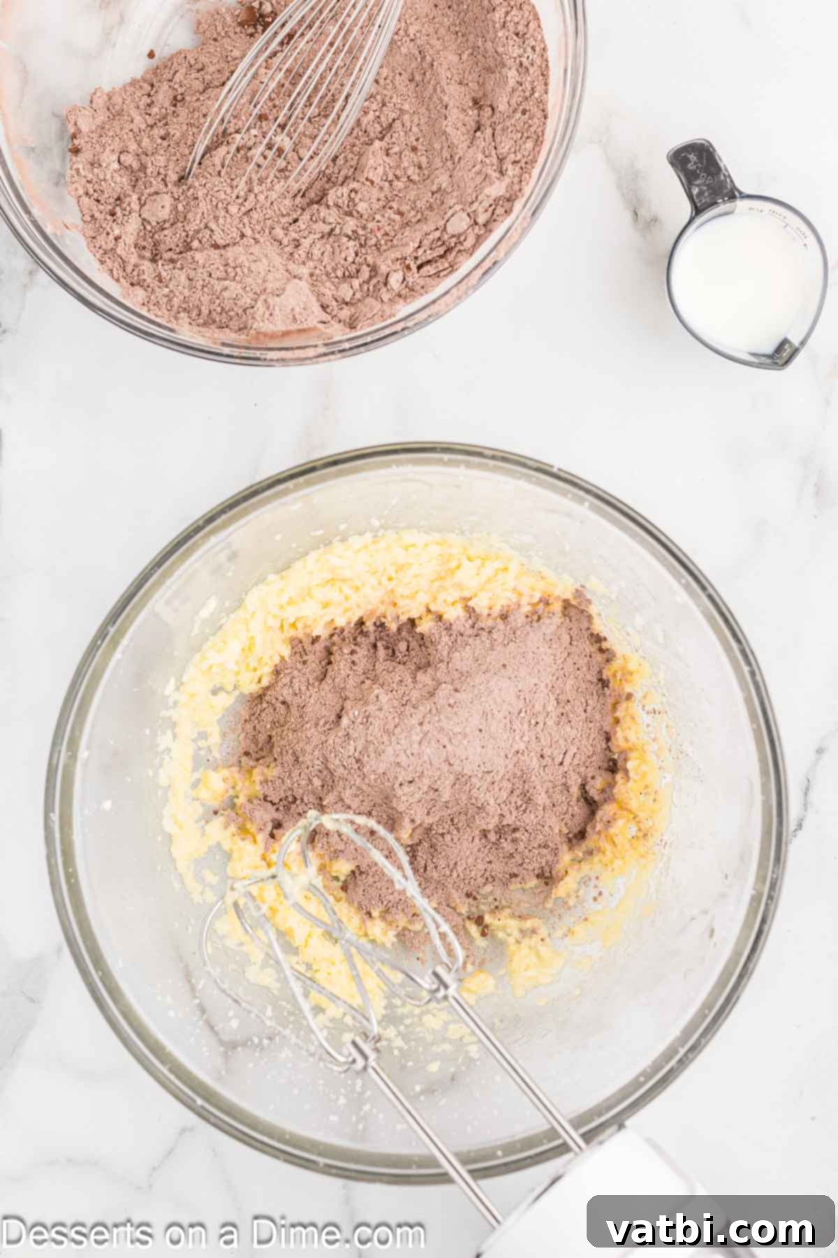 Layered Chocolate Delights 6 The whisked dry ingredients are slowly being added to the creamy butter and sugar mixture in a stand mixer bowl.