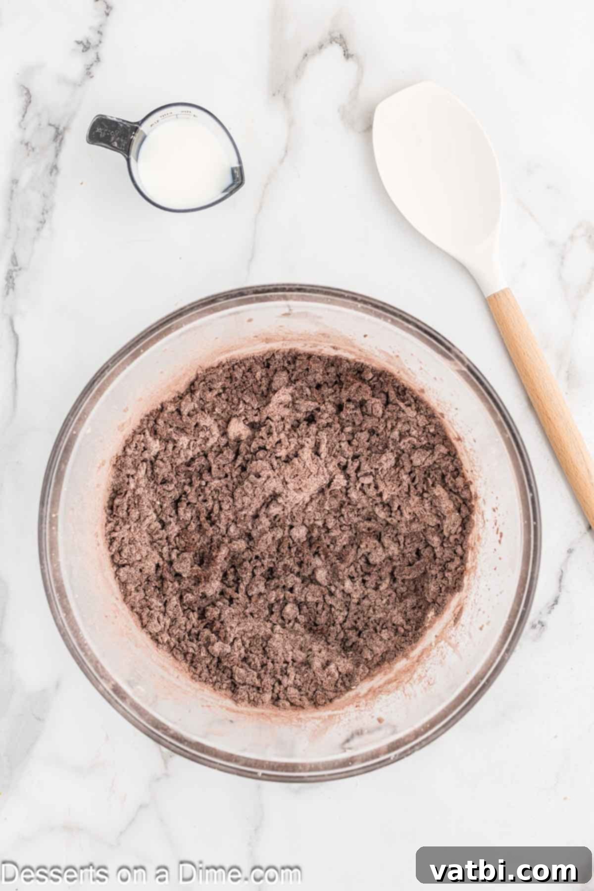Crispy Chocolate Wafer Delights 7 Wet and dry ingredients mixed together into a dark chocolate dough in a bowl.