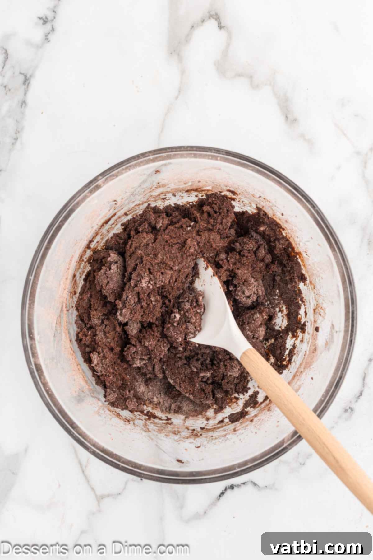 Crispy Chocolate Wafer Delights 8 Milk being added to the chocolate cookie mixture and stirred in a bowl.