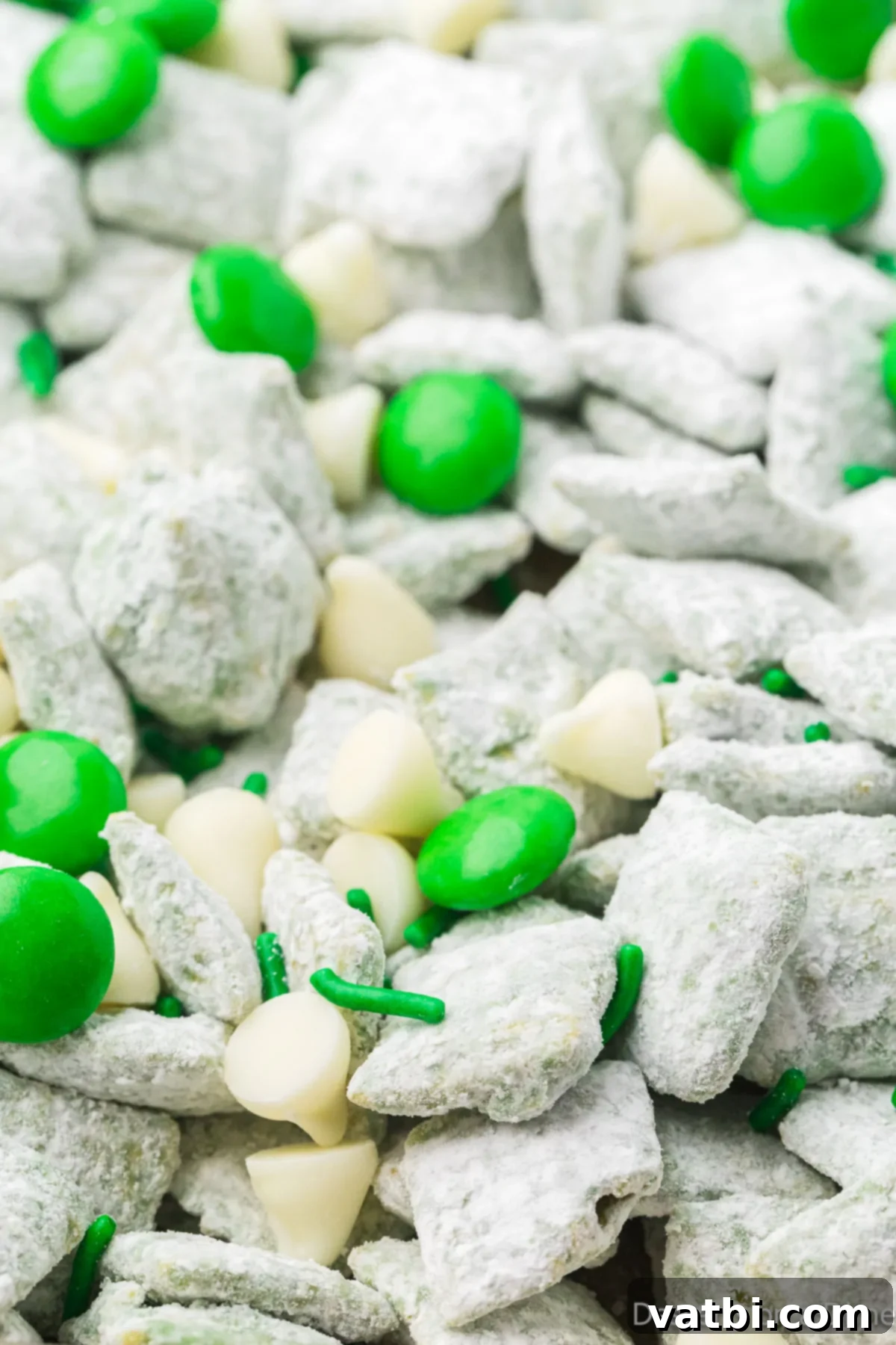A close-up shot of St. Patrick's Day Puppy Chow in a decorative bowl, ready to be enjoyed.