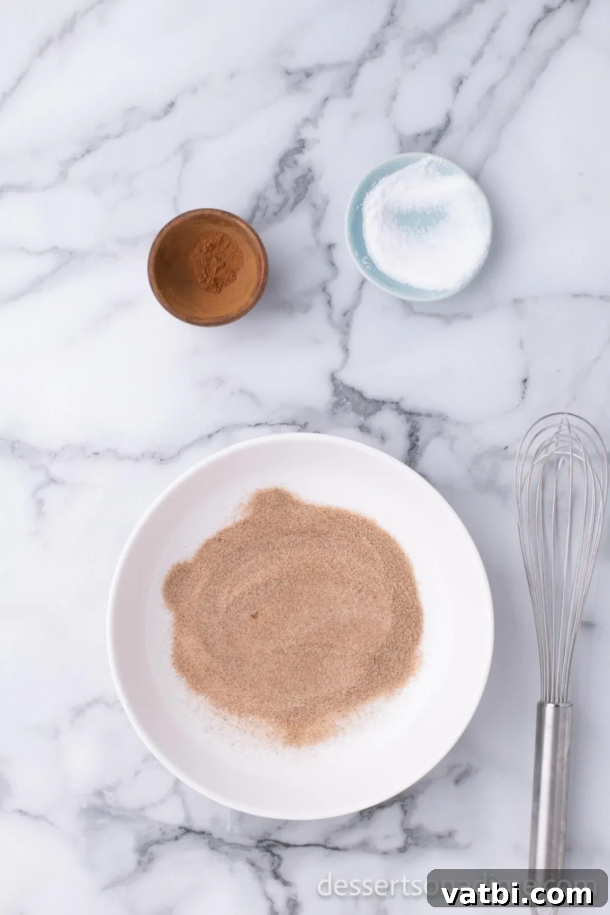Homemade Elephant Ear Perfection 12 A small mixing bowl containing granulated sugar and ground cinnamon, perfectly blended together to create the classic elephant ears topping.