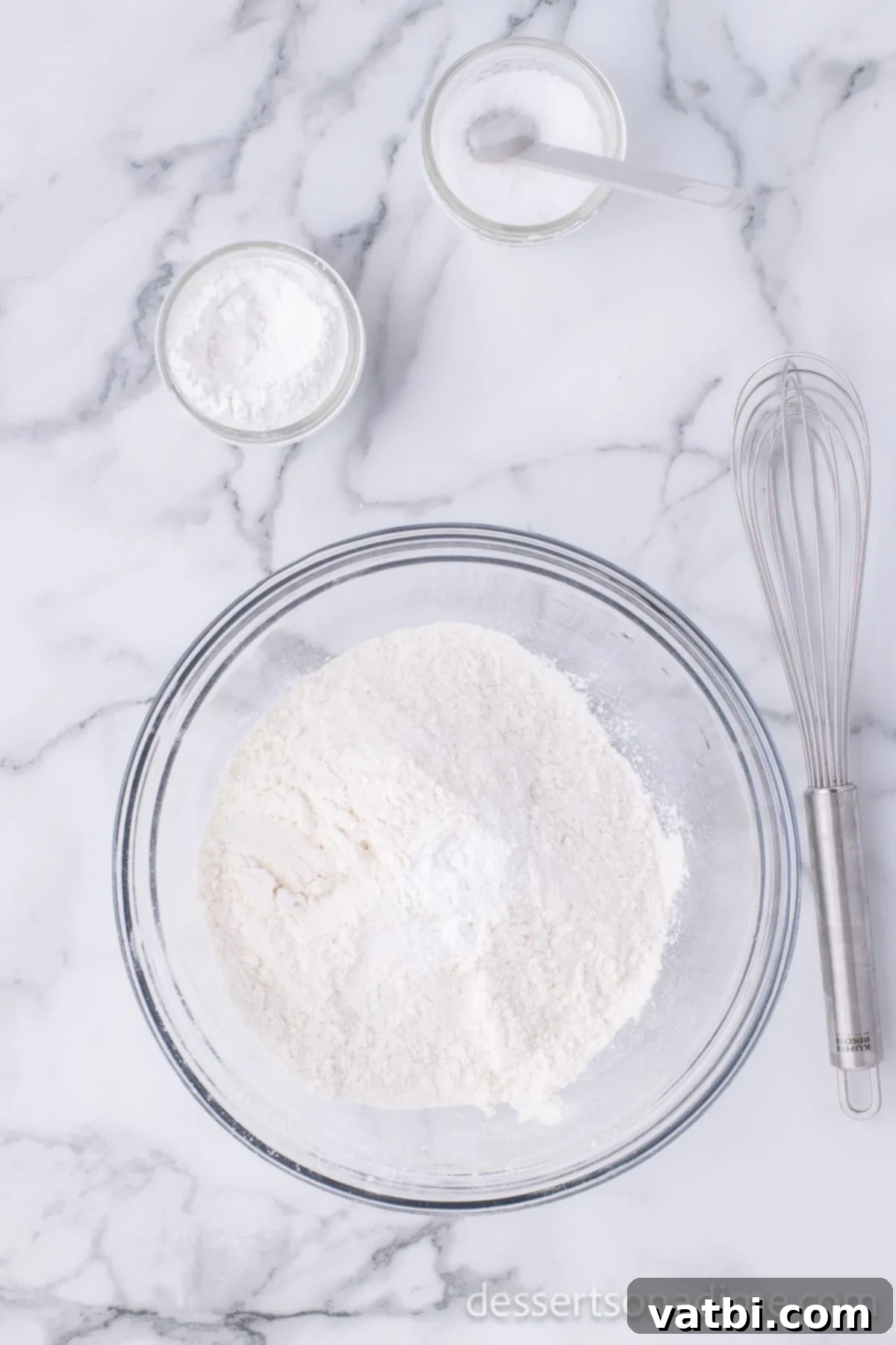Homemade Elephant Ear Perfection 4 A medium mixing bowl containing flour, salt, and baking powder, stirred together to combine the dry ingredients.