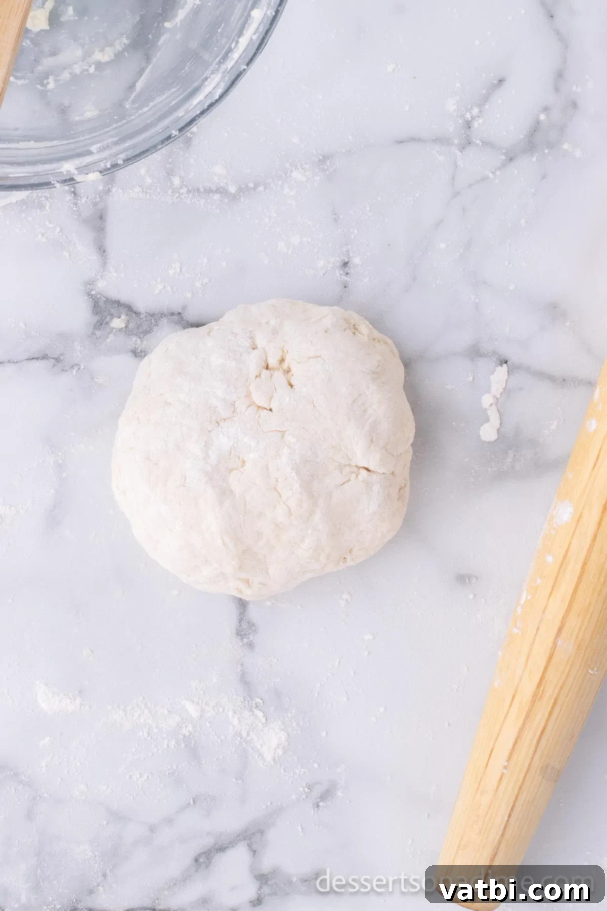Homemade Elephant Ear Perfection 6 The freshly formed dough, shaped into a smooth ball, resting on a clean countertop, ready for its brief resting period.