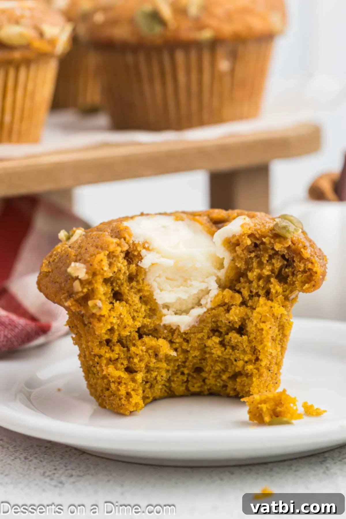 Starbucks Autumn Pumpkin Cream Cheese Muffins 14 A single Starbucks Pumpkin Muffin with cream cheese filling on a plate.