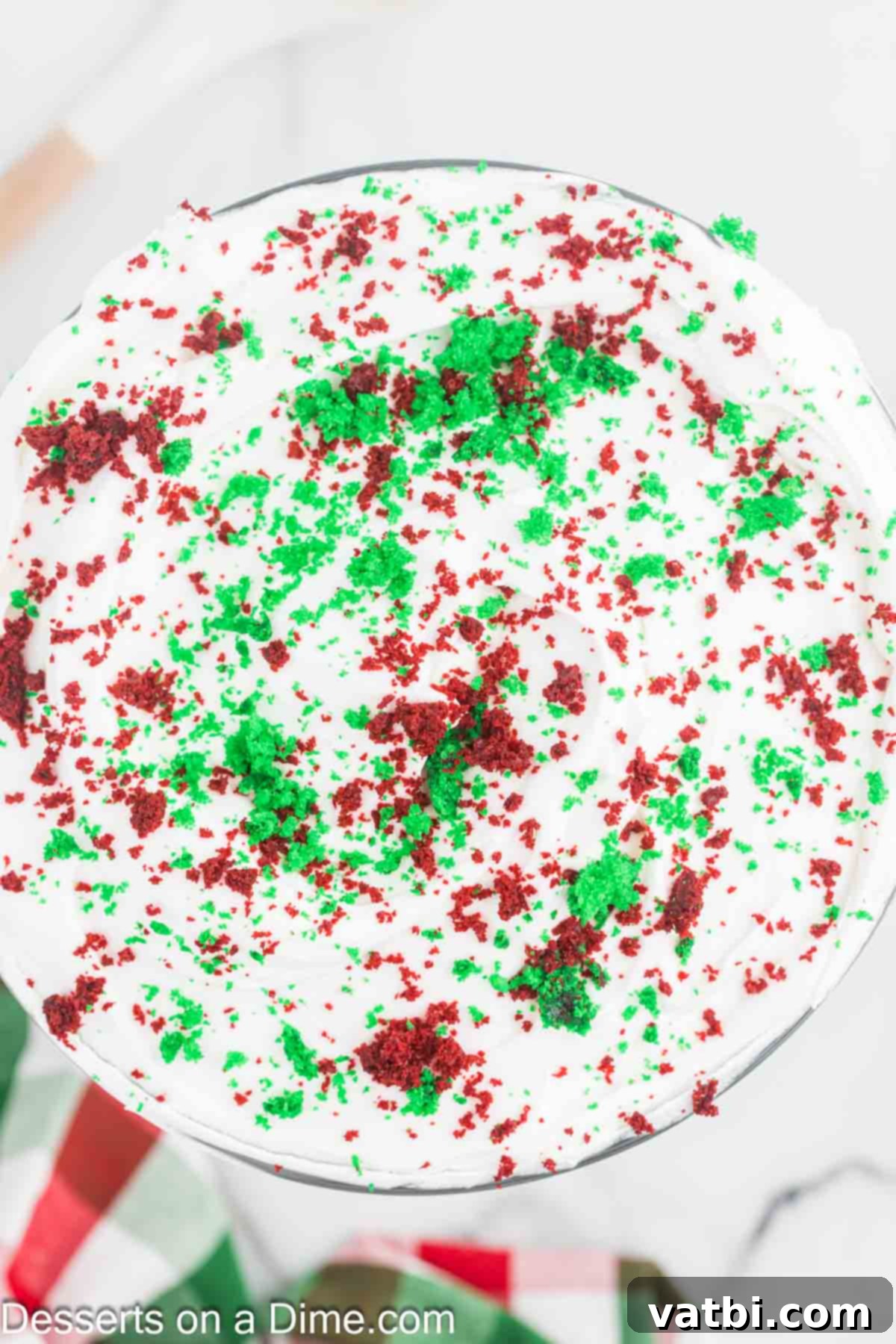 Festive Trifle Delight 11 Final layer of whipped cream and cake crumbs on top of the trifle.