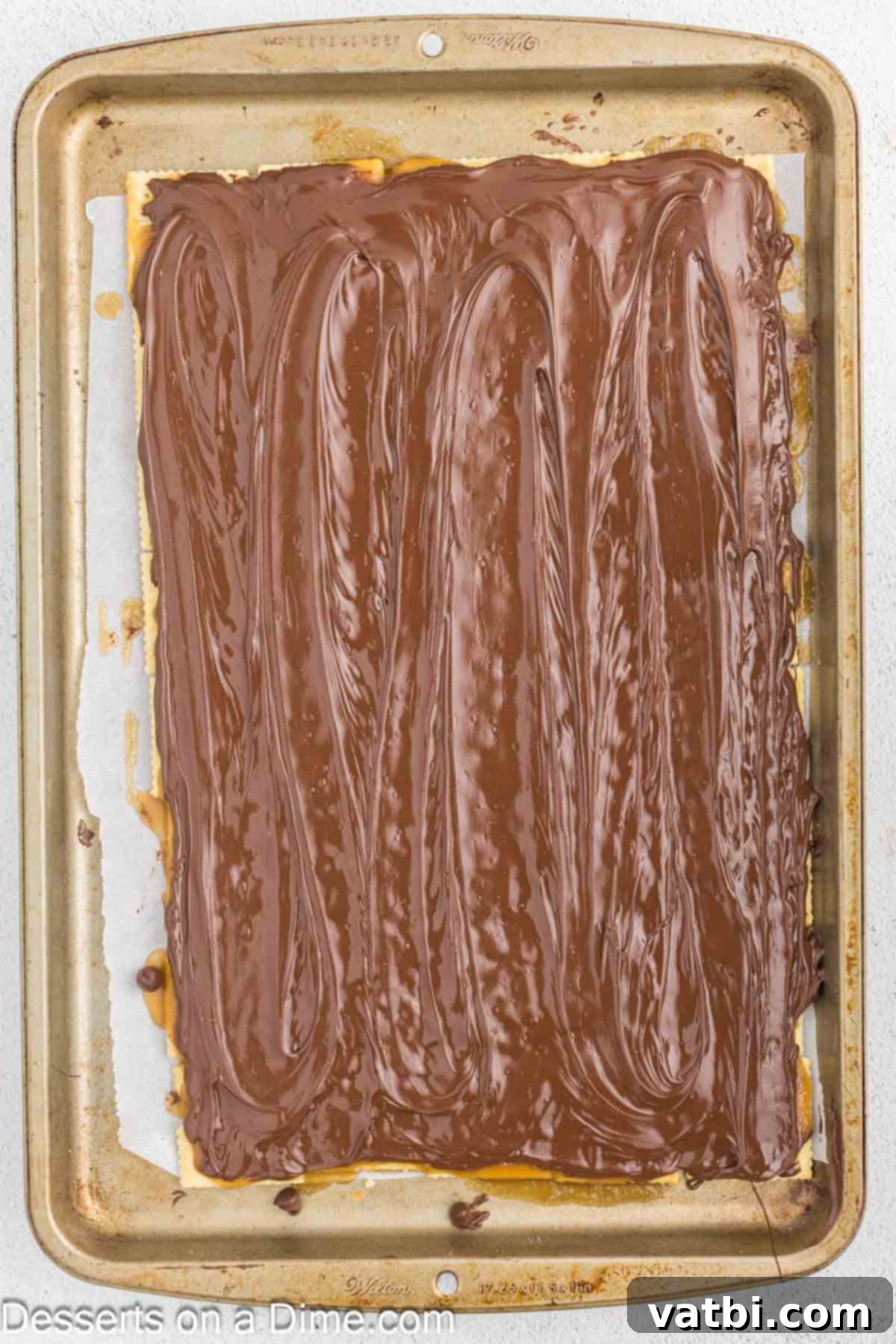 Melted chocolate spread smoothly over the baking sheet.