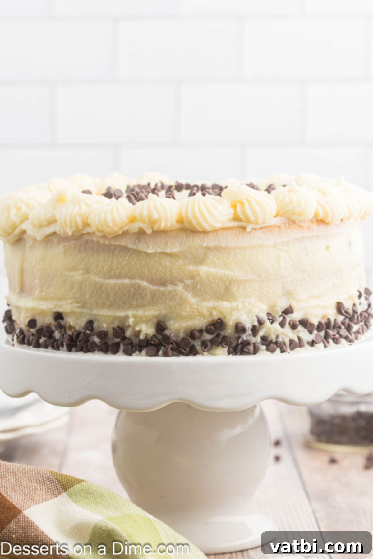 Italian Ricotta Dream Cake 12 The stunning three-layer Cannoli Cake presented beautifully on a cake stand, ready for a special occasion.