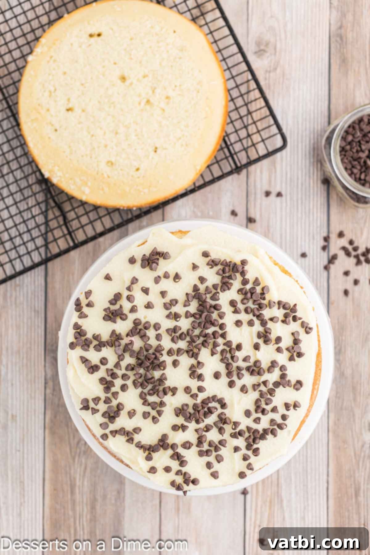 Italian Ricotta Dream Cake 9 A cake layer beautifully frosted and sprinkled with mini chocolate chips, ready for the next layer.
