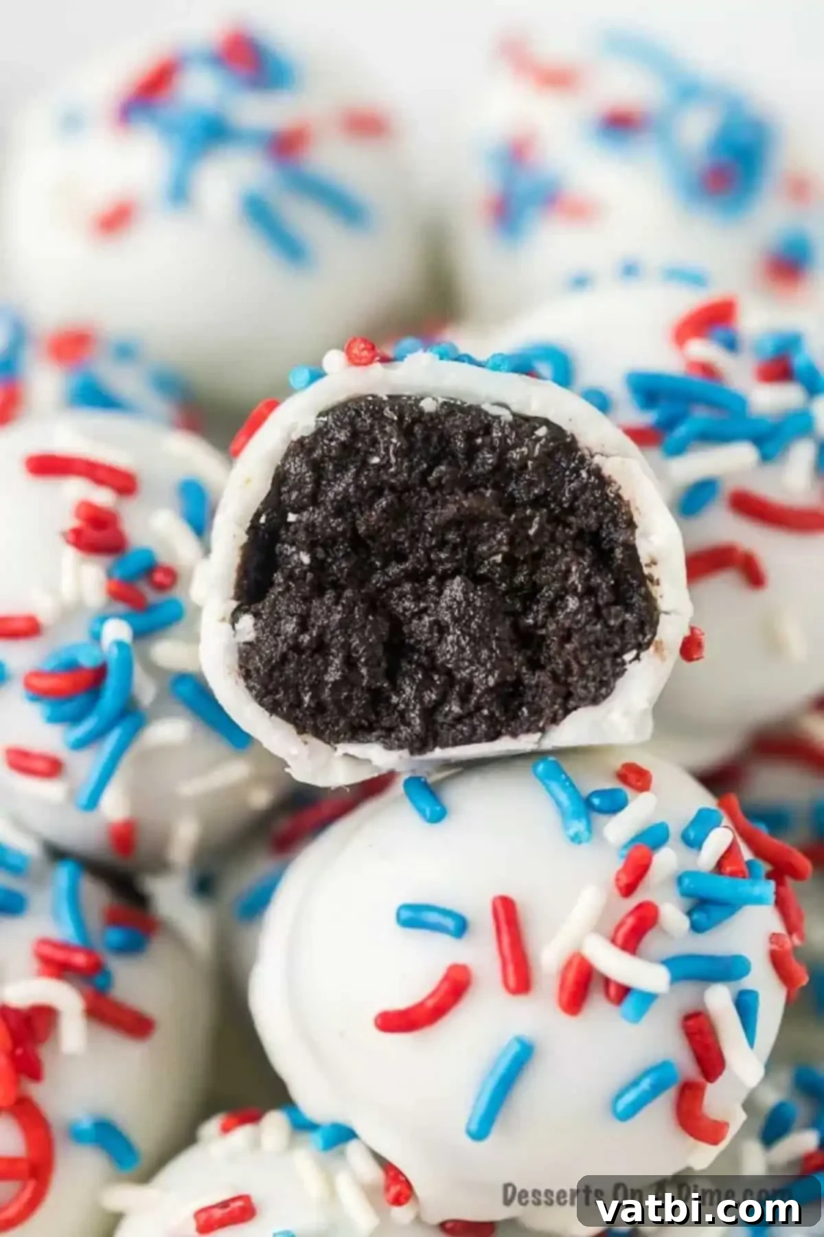 Star-Spangled Oreo Truffles 2 Patriotic Oreo Balls stacked on top of each other, showcasing their vibrant red, white, and blue sprinkles, ready for a festive celebration.