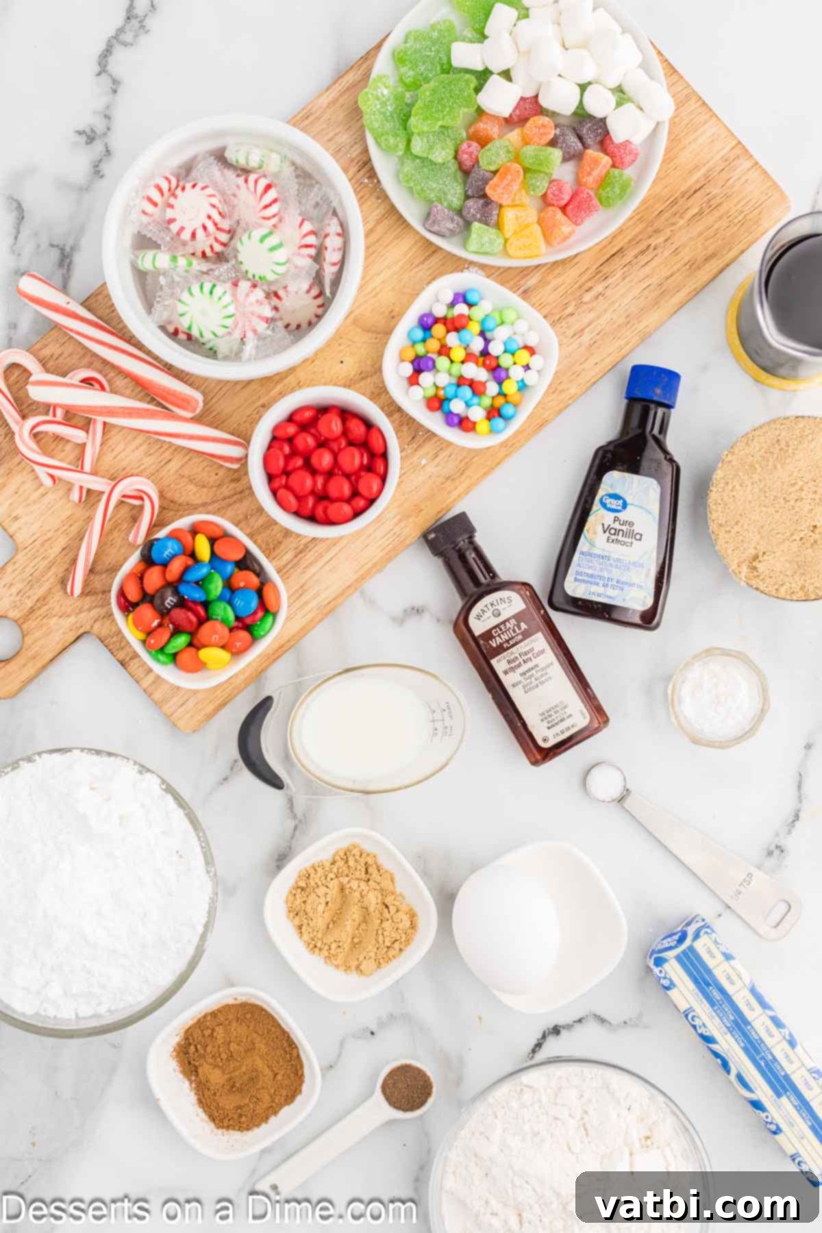 Ingredients for gingerbread house - flour, ginger, cinnamon, allspice, butter, brown sugar, vanilla, molasses, powdered sugar, eggs, candy. 