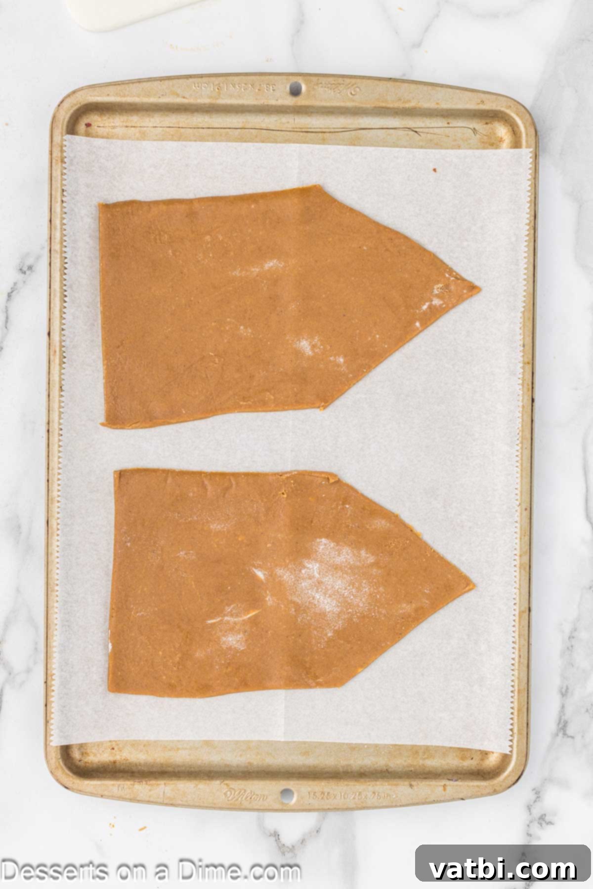 Gingerbread pieces on baking sheet. 