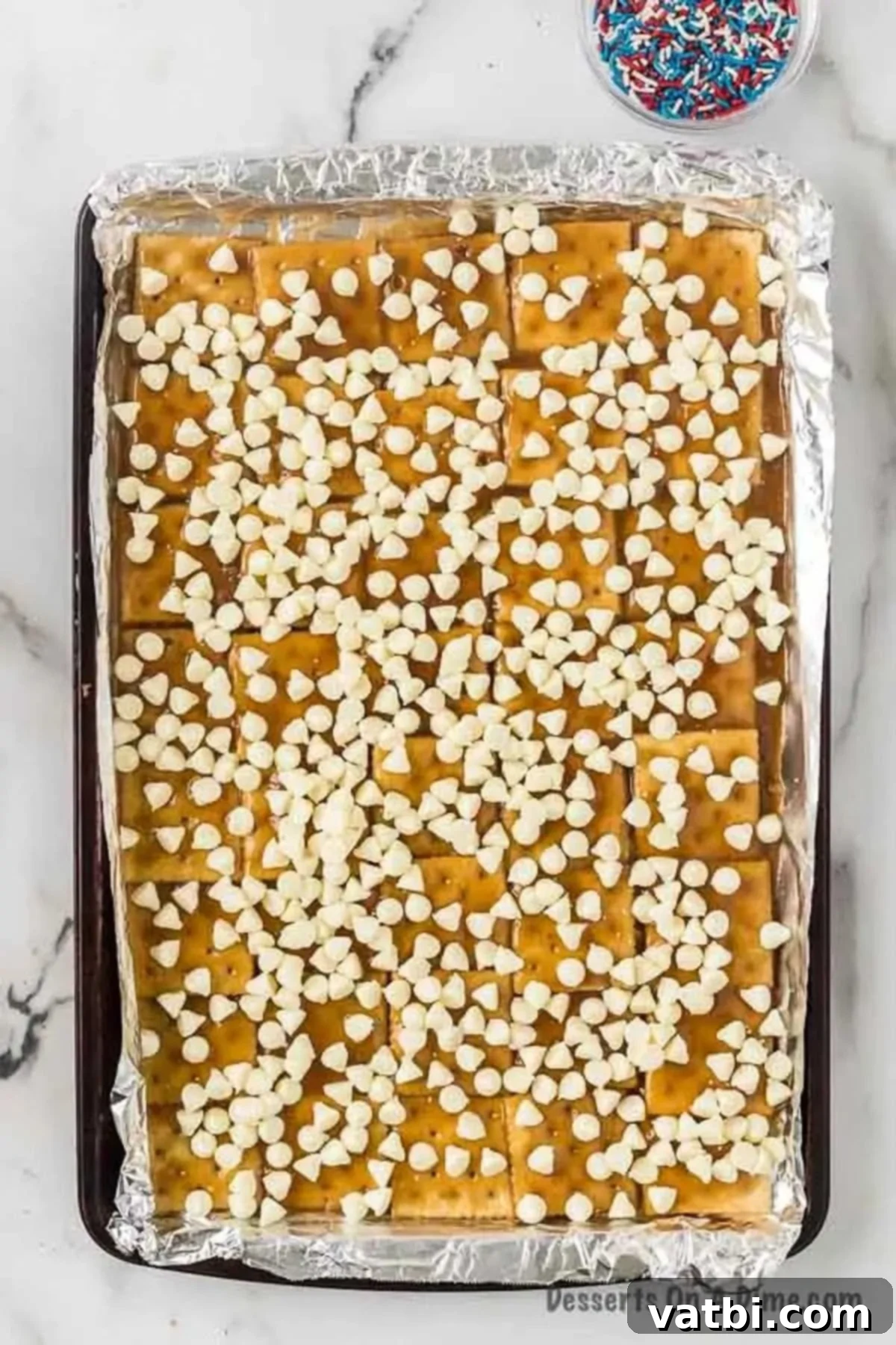 White chocolate chips sprinkled on top of pan.