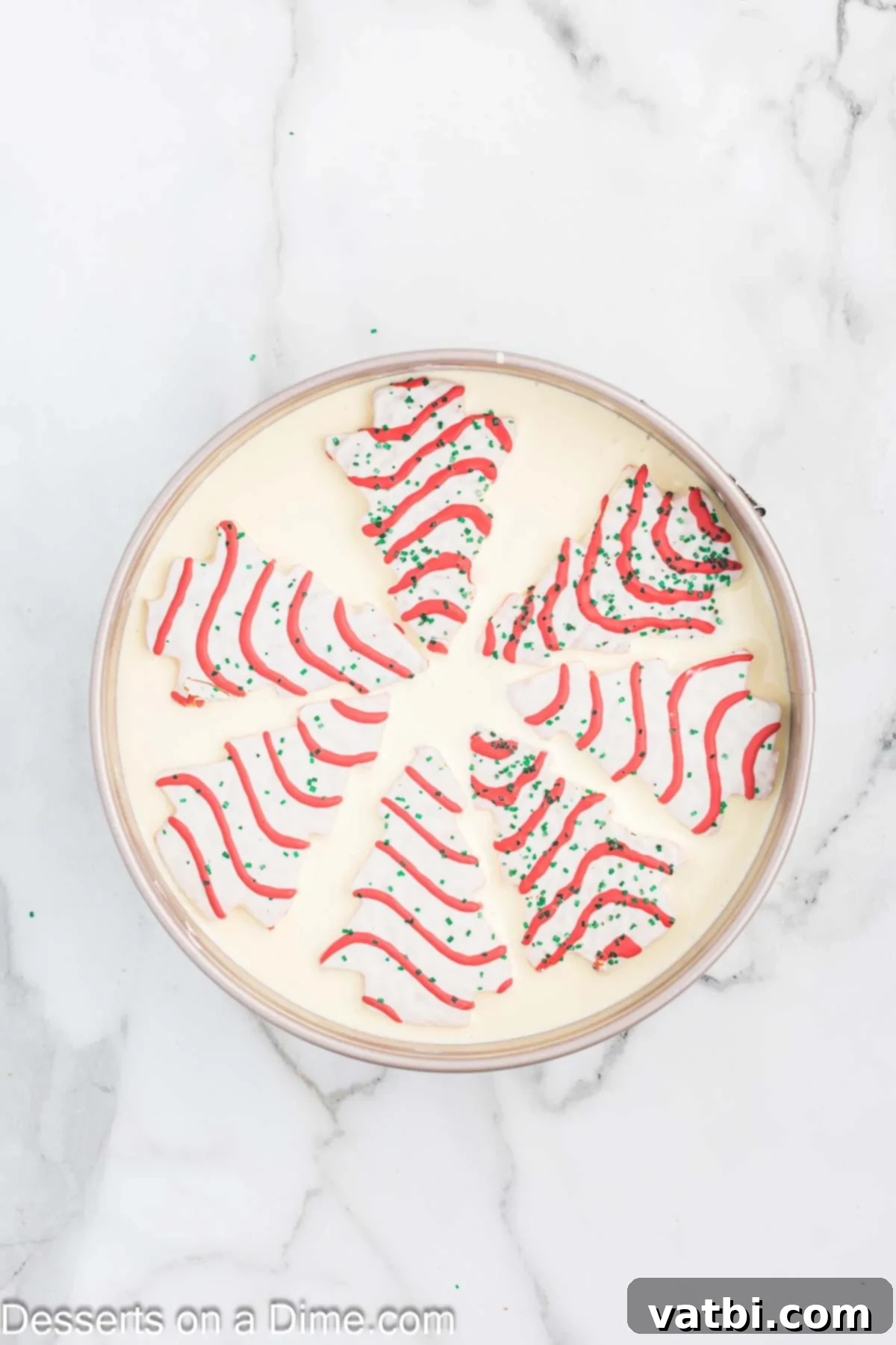 Little Debbie Christmas Tree Cheesecake: A Festive Indulgence 11 Little Debbie Christmas Tree Cakes carefully placed on top of the first layer of cheesecake batter.