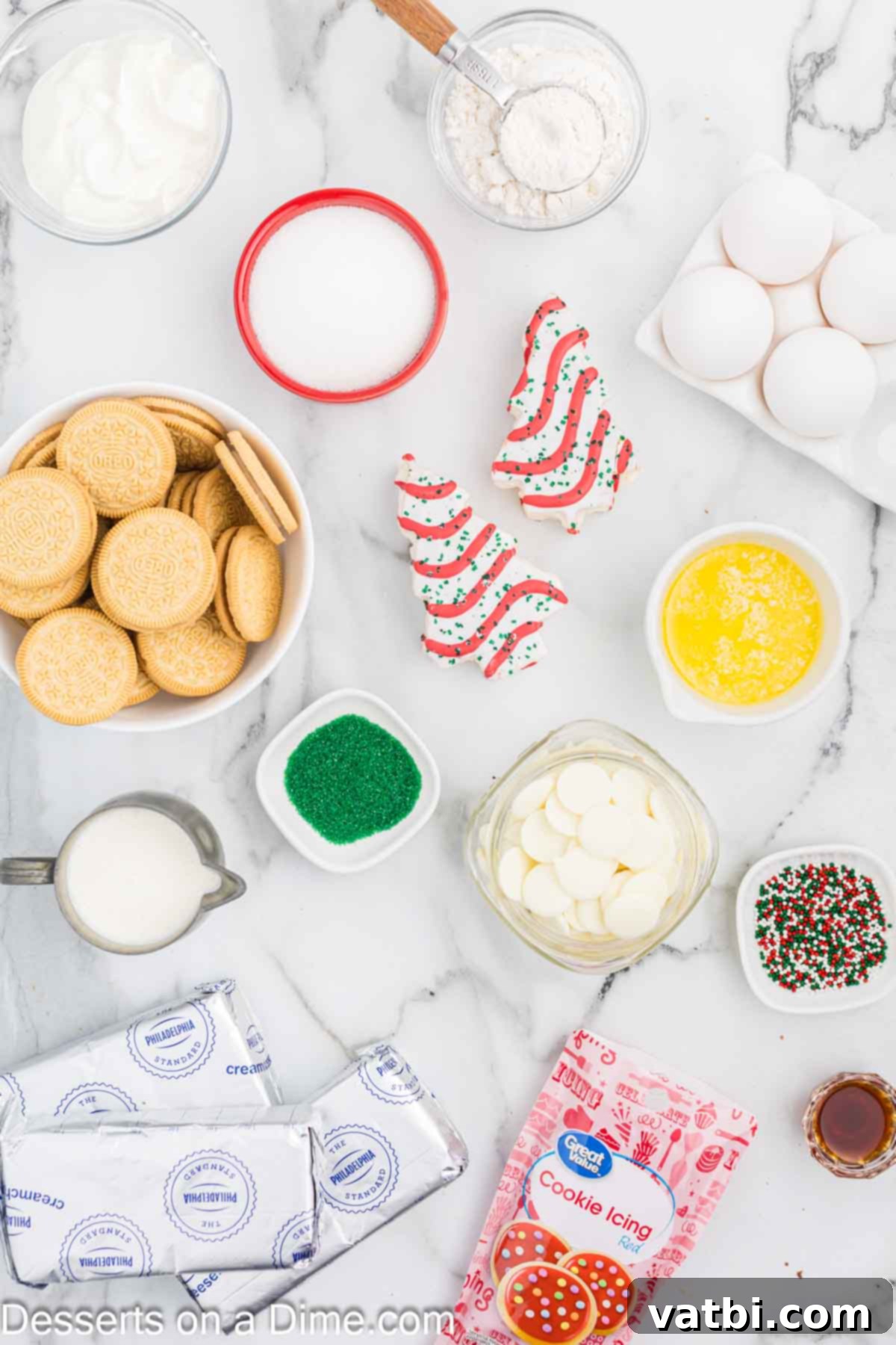Little Debbie Christmas Tree Cheesecake: A Festive Indulgence 3 A selection of ingredients for Little Debbie Christmas Tree Cheesecake including Golden Oreos, butter, Christmas sprinkles, cream cheese, sugar, vanilla, sour cream, eggs, Christmas tree cakes, white baking chocolate, and heavy whipping cream.