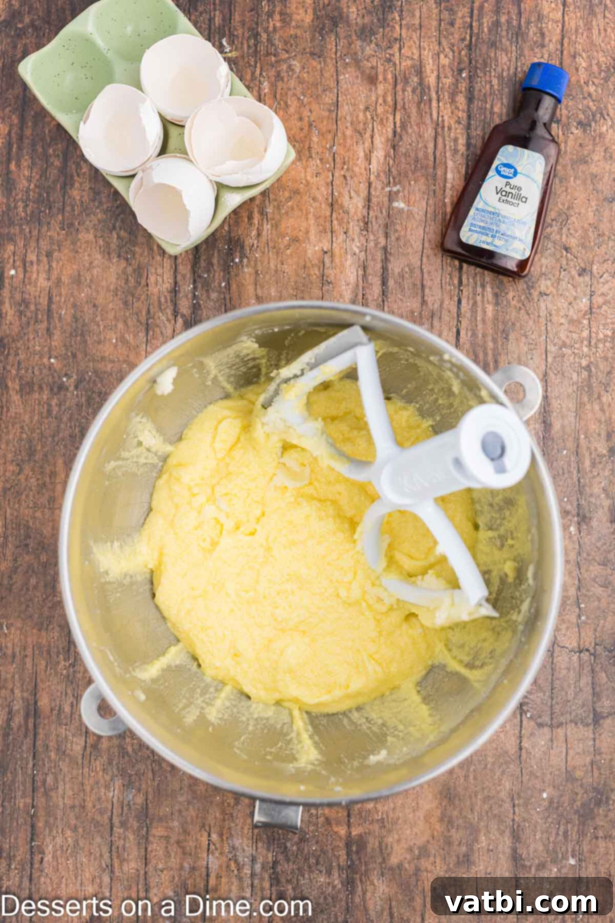 Eggs added into butter mixture in mixing bowl. 