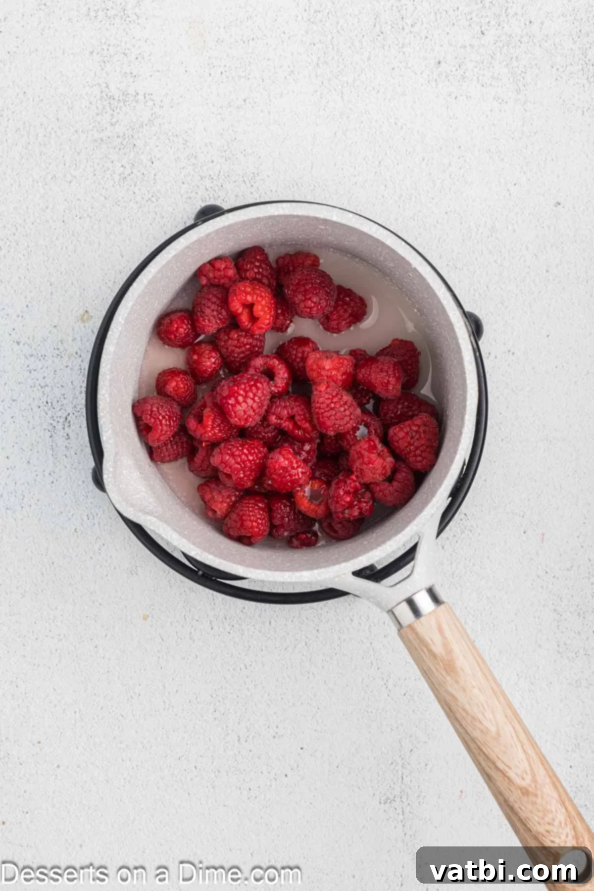 Decadent Chocolate Raspberry Cake 9 Fresh raspberries, sugar, and cornstarch in a small saucepan, starting to cook for the raspberry filling.
