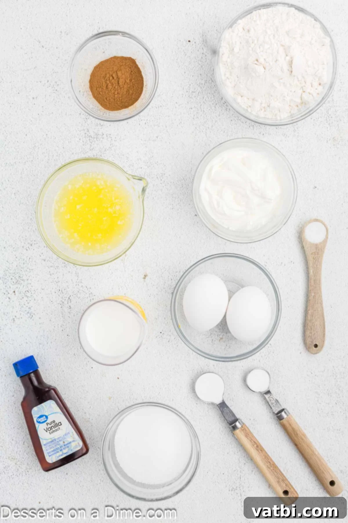 Decadent Churro Cake 3 Collection of churro cake ingredients including all-purpose flour, baking soda, butter, cinnamon, sugar, eggs, sour cream, vanilla extract, and milk.